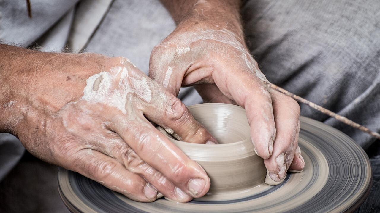 insegnante di ceramica che lavora l'argilla con le mani