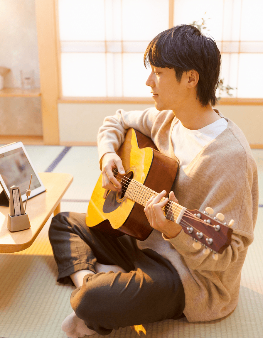 自宅でギターコードを練習する男性