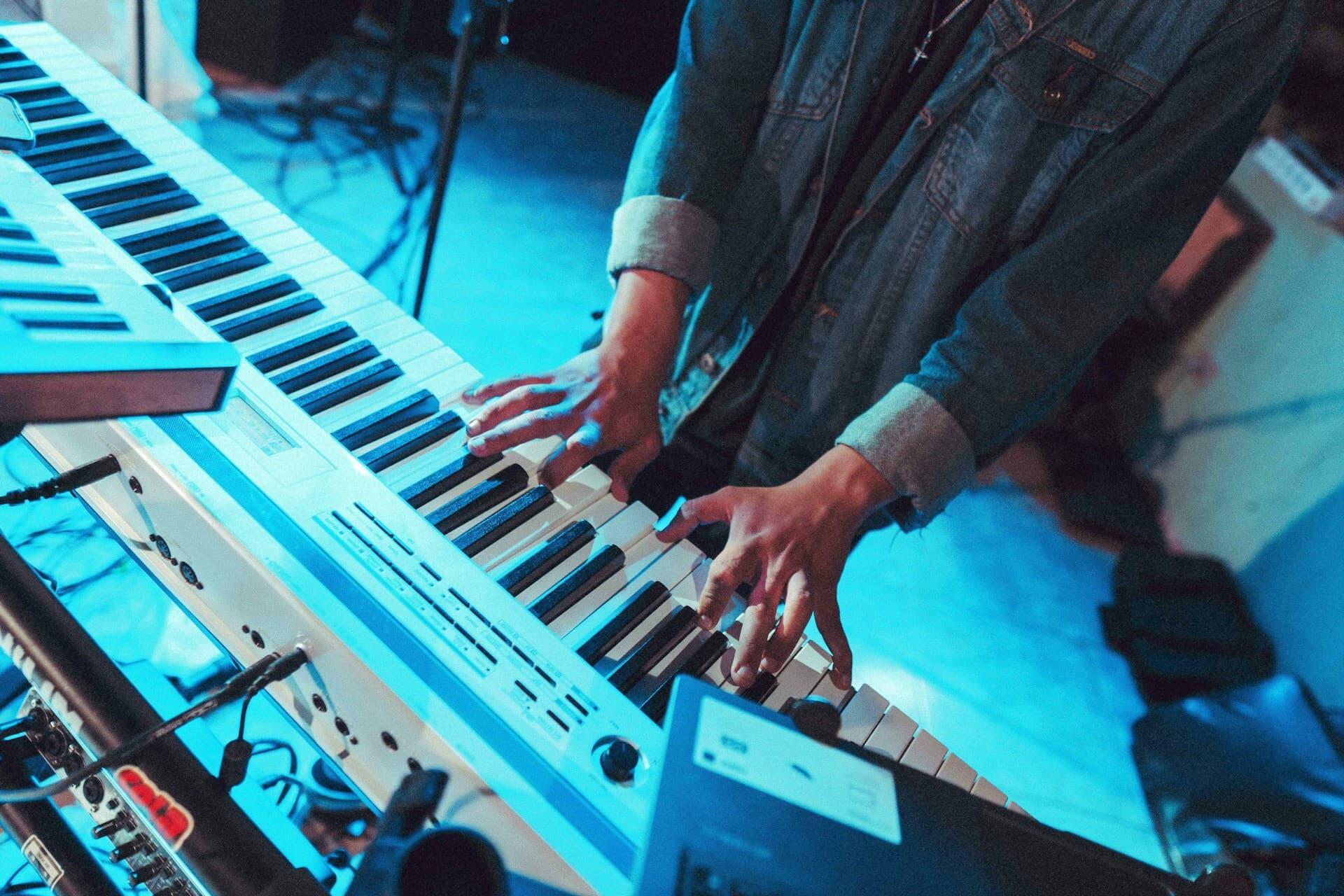 ライブステージでキーボードを演奏する手元