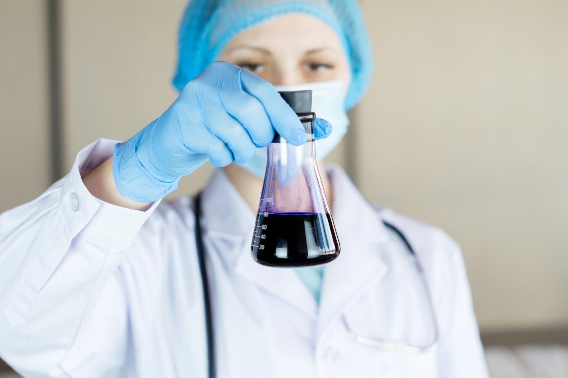 Ligoninės laboratorijos darbuotoja su mėginiu