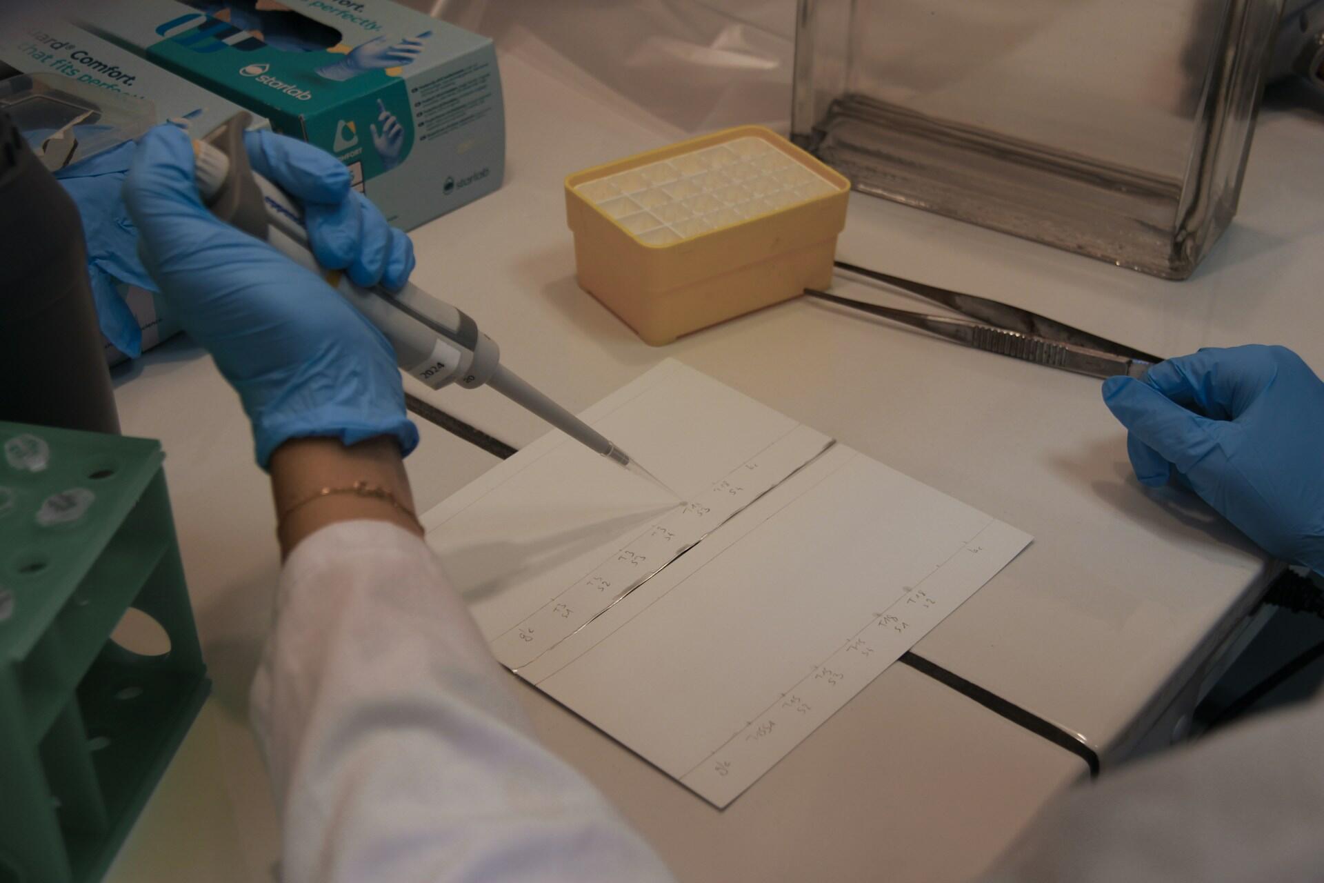 Žmogus naudojasi chemijos įranga laboratorijoje.