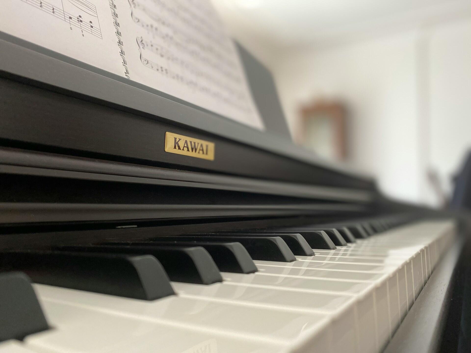 Skaitmeninio pianino klaviatūros ir stovo su natomis vaizdas iš arti