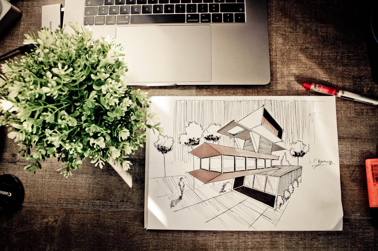 dessin d'une maison d'architecte posé devant un laptop
