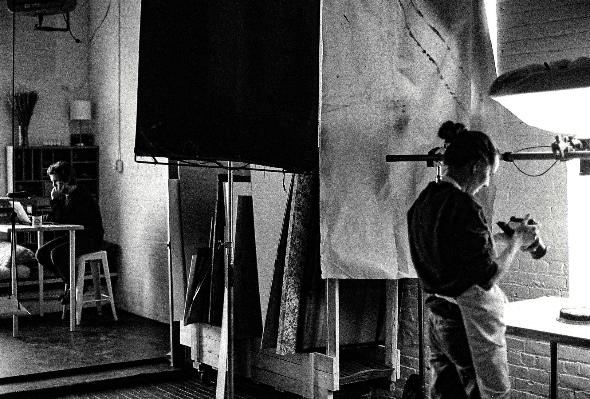 Femme qui prend en photo un gâteau dans un studio