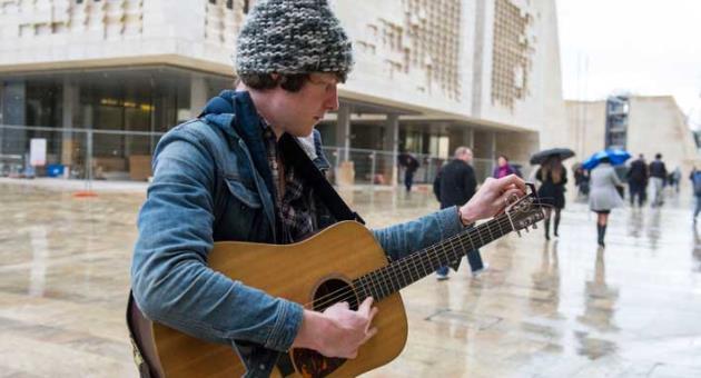 a boy playing guitar in Malta