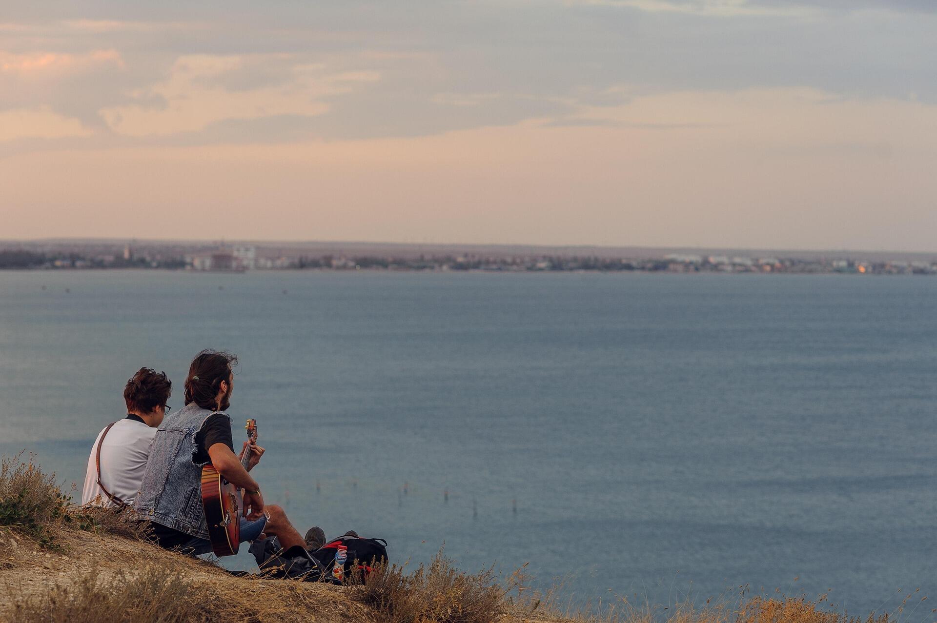 Maltese street musician playing country-inspired acoustic guitar in Valletta