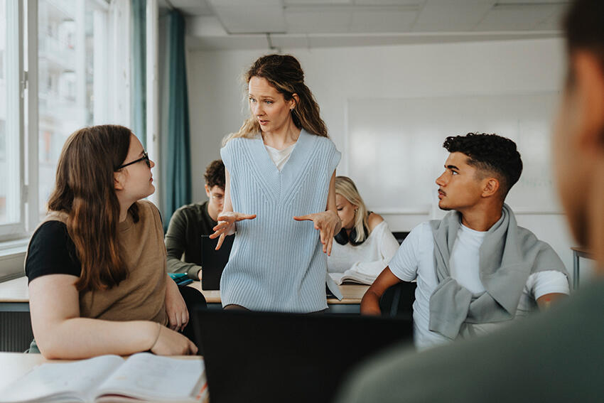 teacher guiding students during an interactive language learning discussion