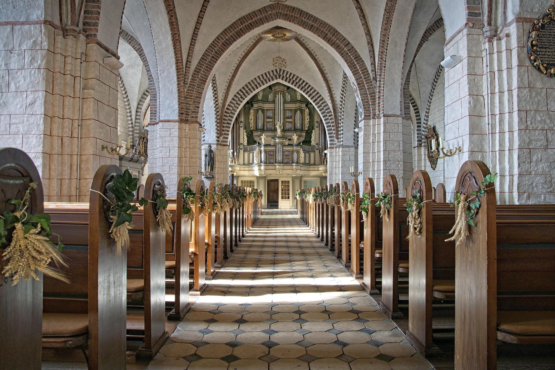 church interior in Malta decorated for Easter Sunday with traditional Holy Week decorations and wooden pews