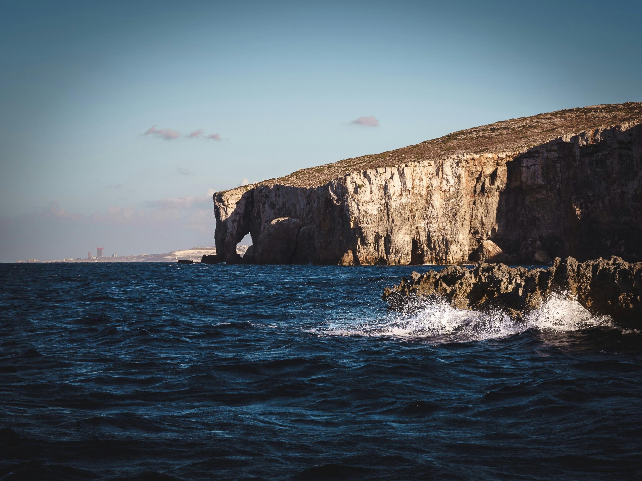 Malta coastline with waves and natural rock arch