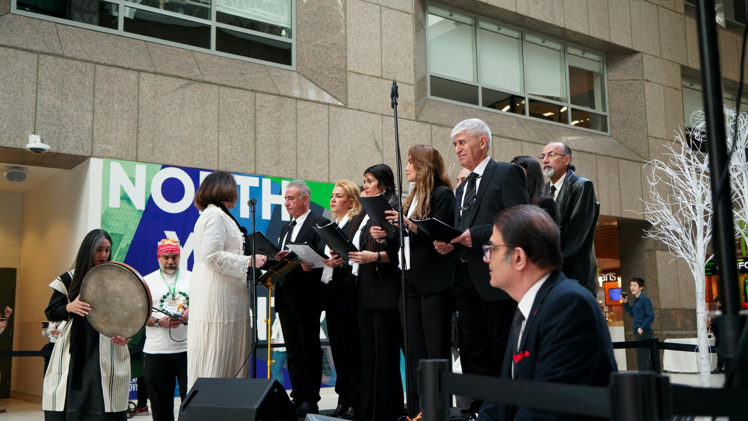 Choir singing together during an outdoor performance.