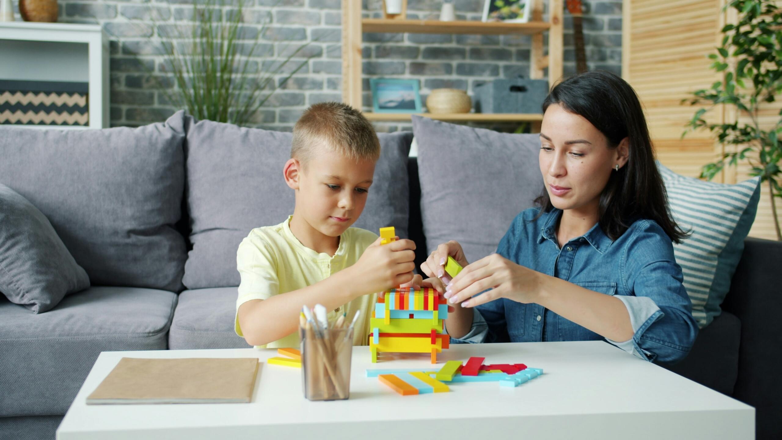 Mother and son building with colourful blocks together