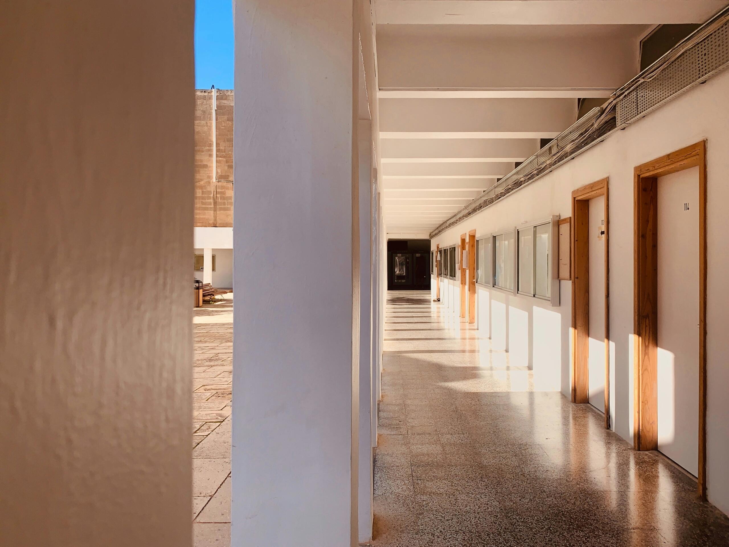 Bright corridor with classroom doors at the University of Malta