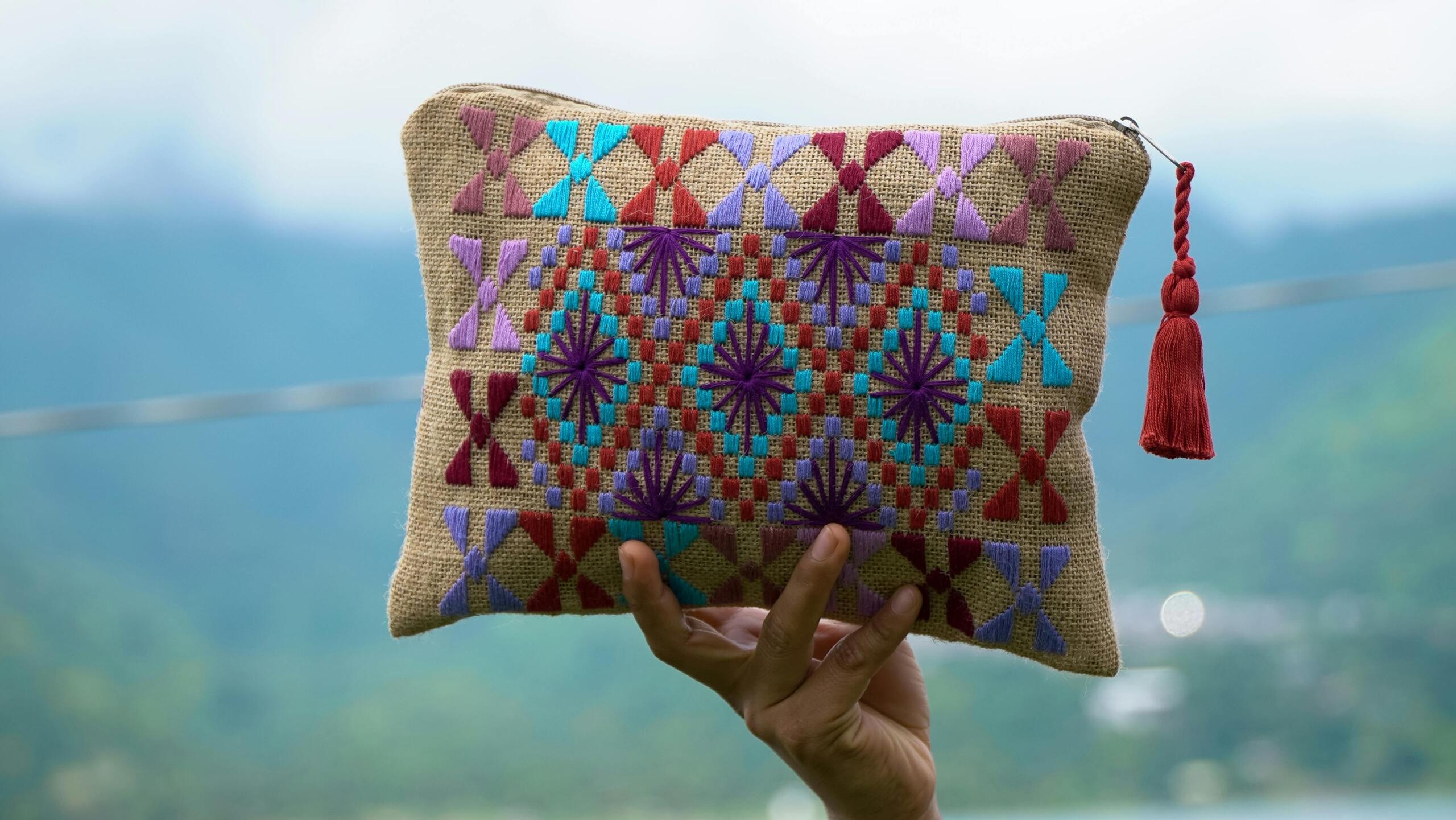 Person holding a colourful pouch