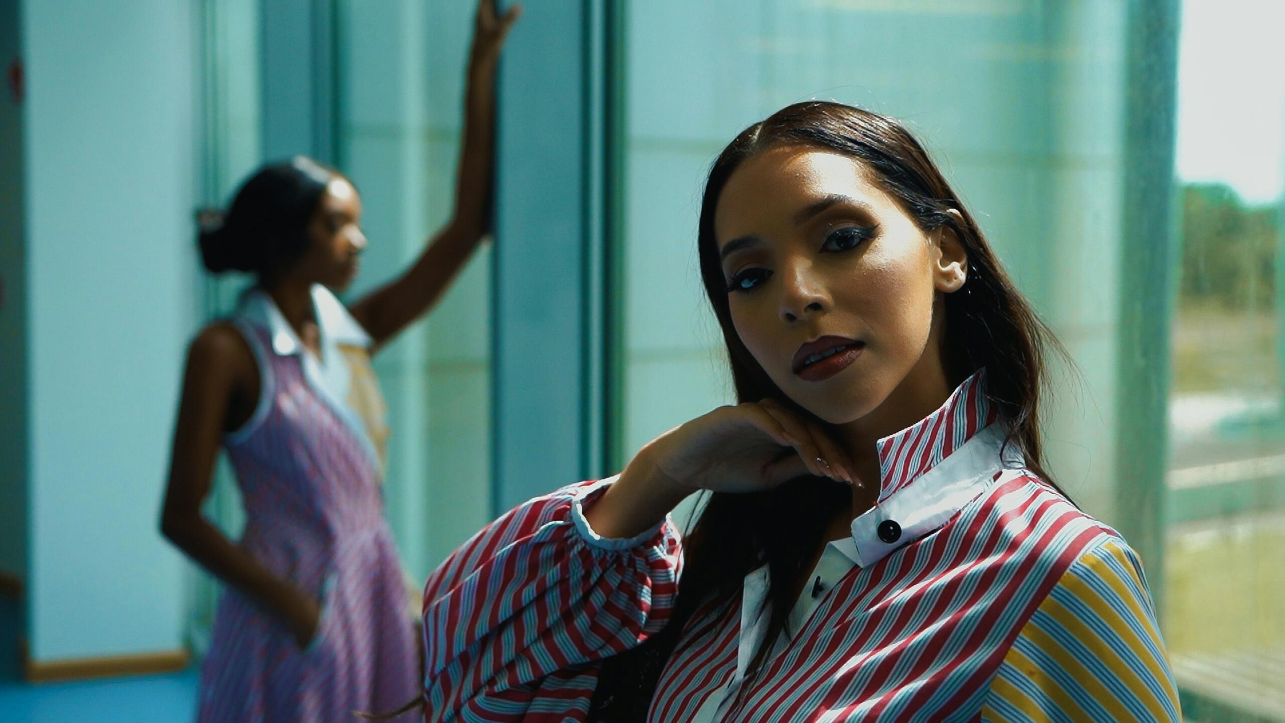 Women posing as models for the camera.