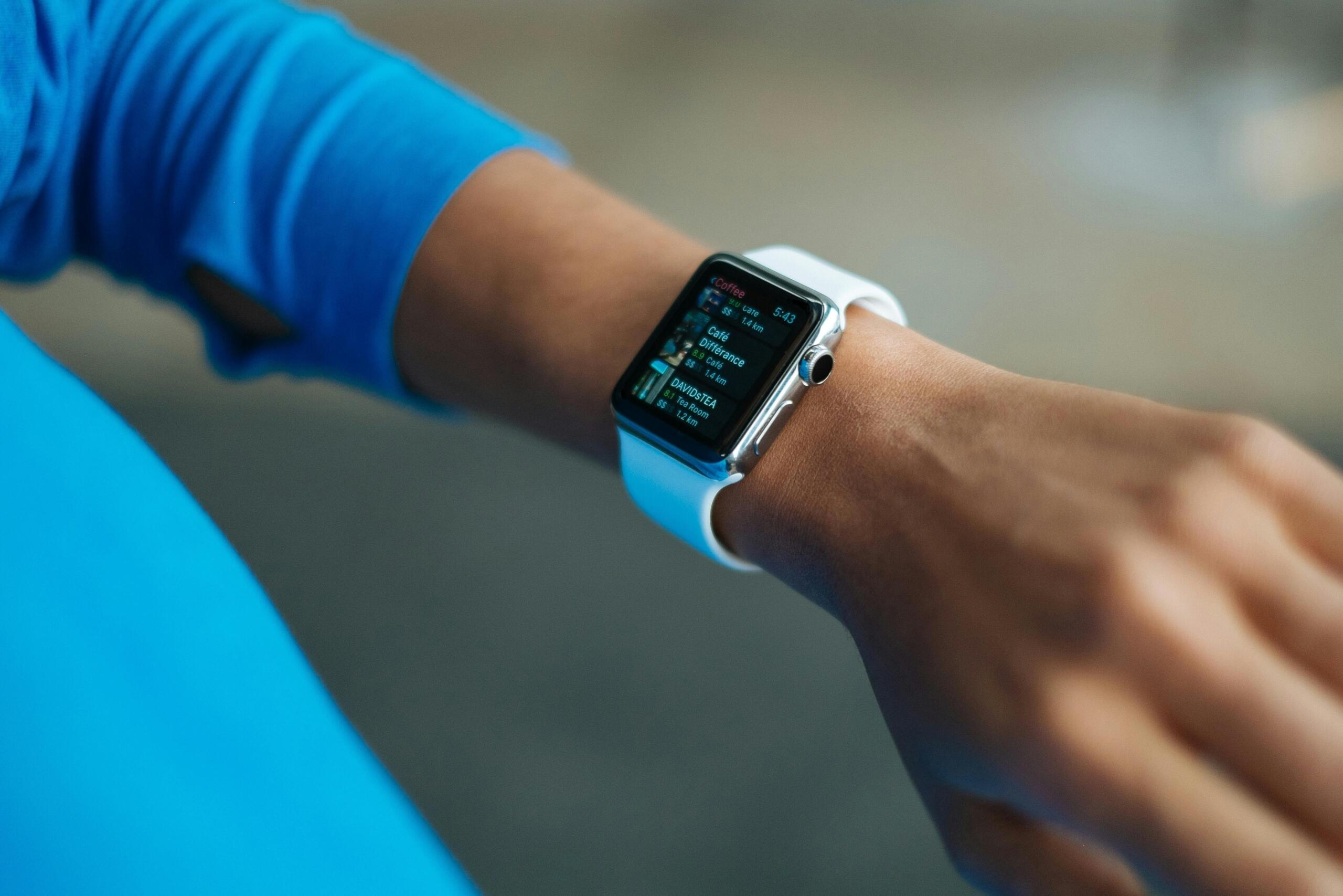 Person wearing a blue smart watch