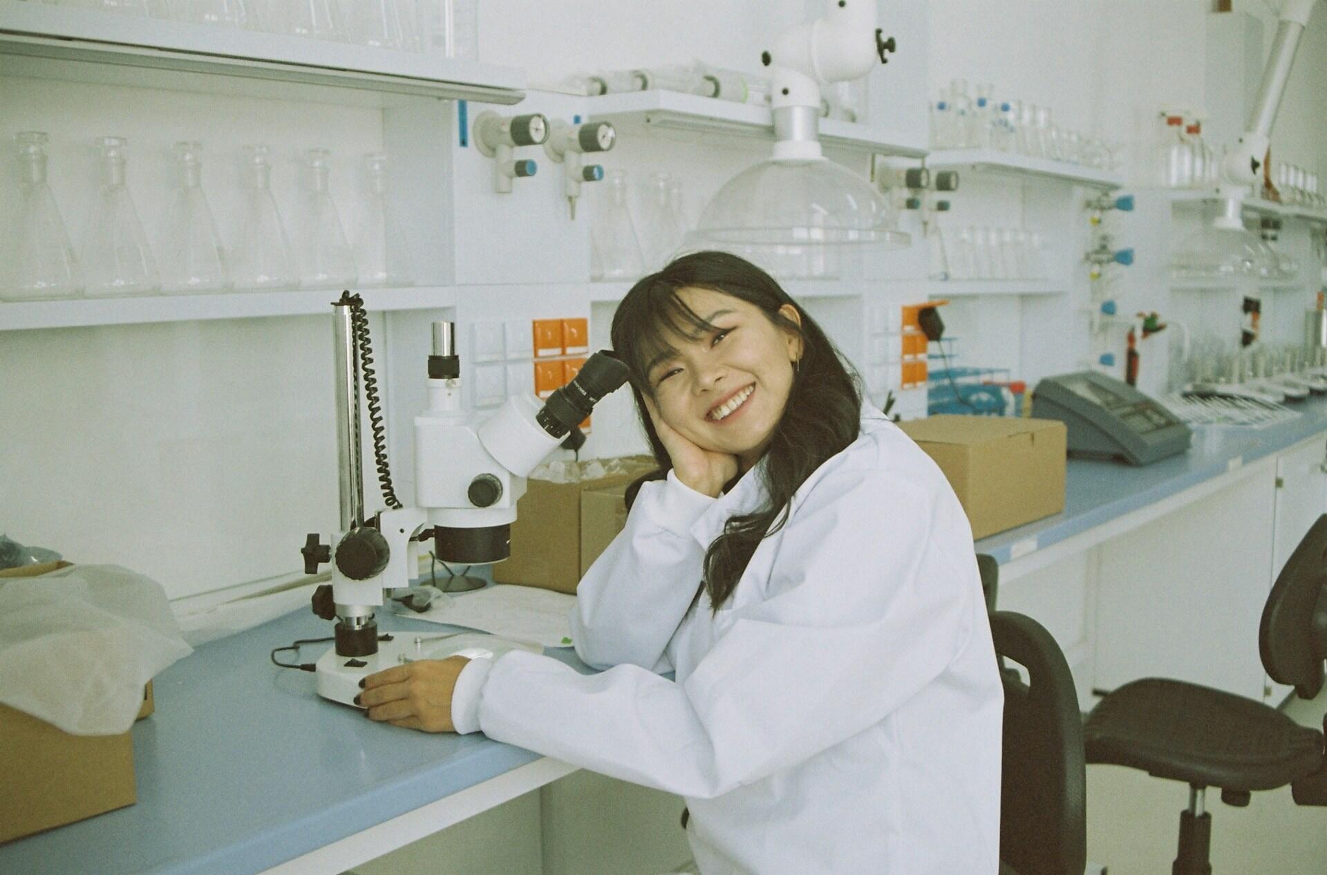 A woman in a white coat in a lab