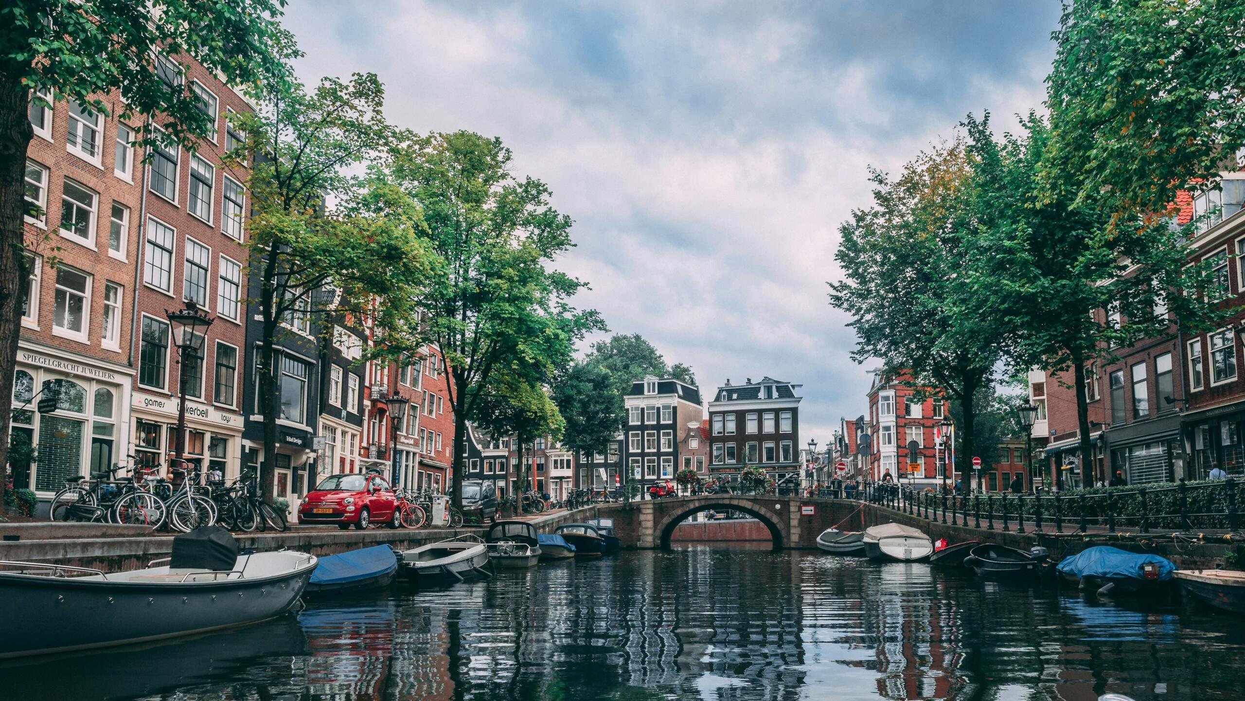 Boats parked along a river in Amsterdam