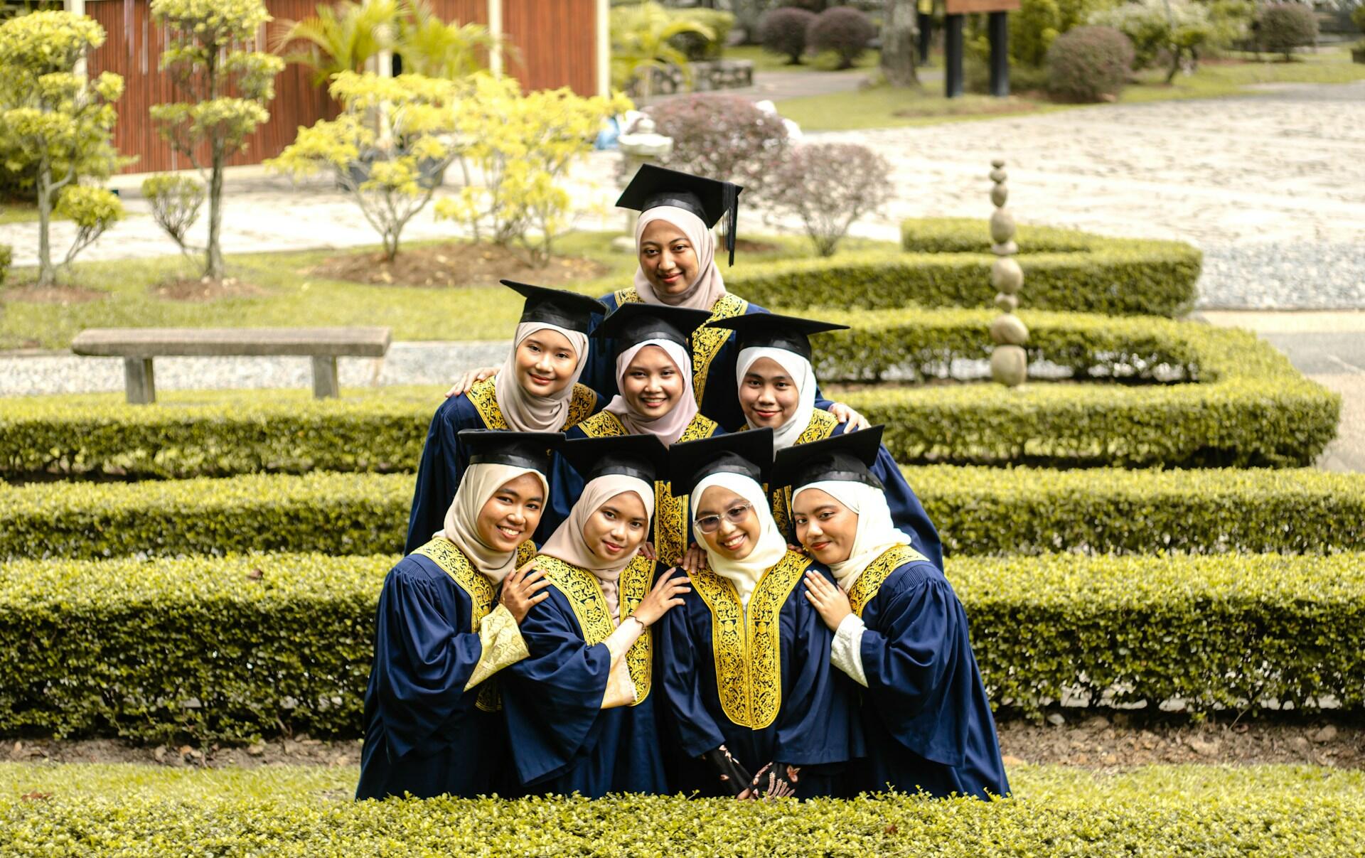 Women in graduation gowns posing for a picture
