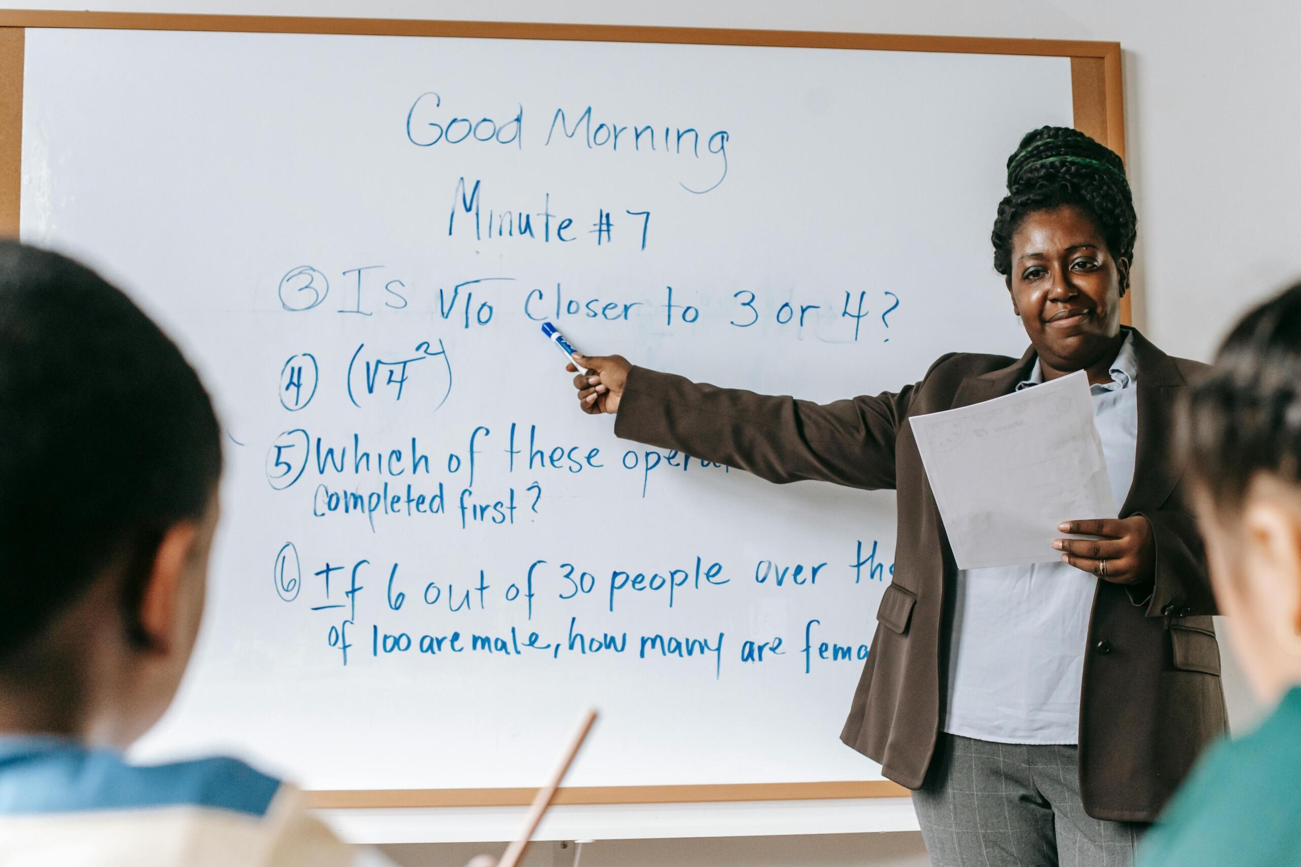 Tutor pointing to whiteboard
