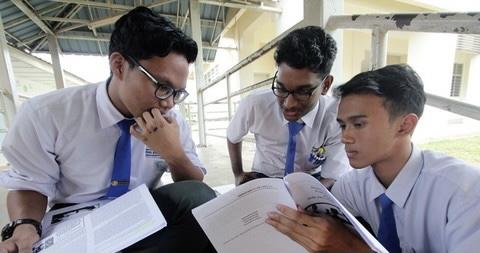 three students revising math together
