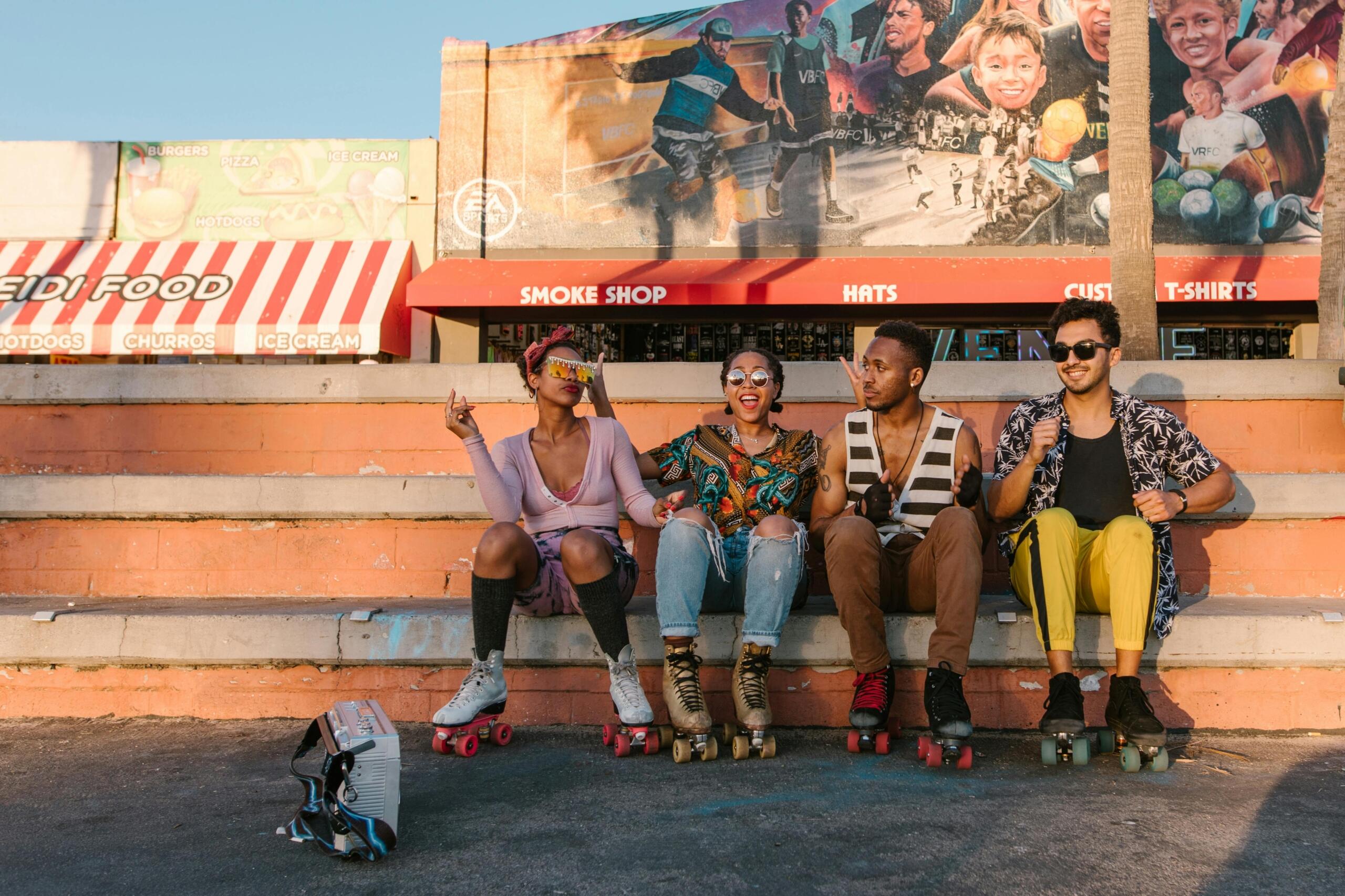 A group of roller skaters sitting on a bench