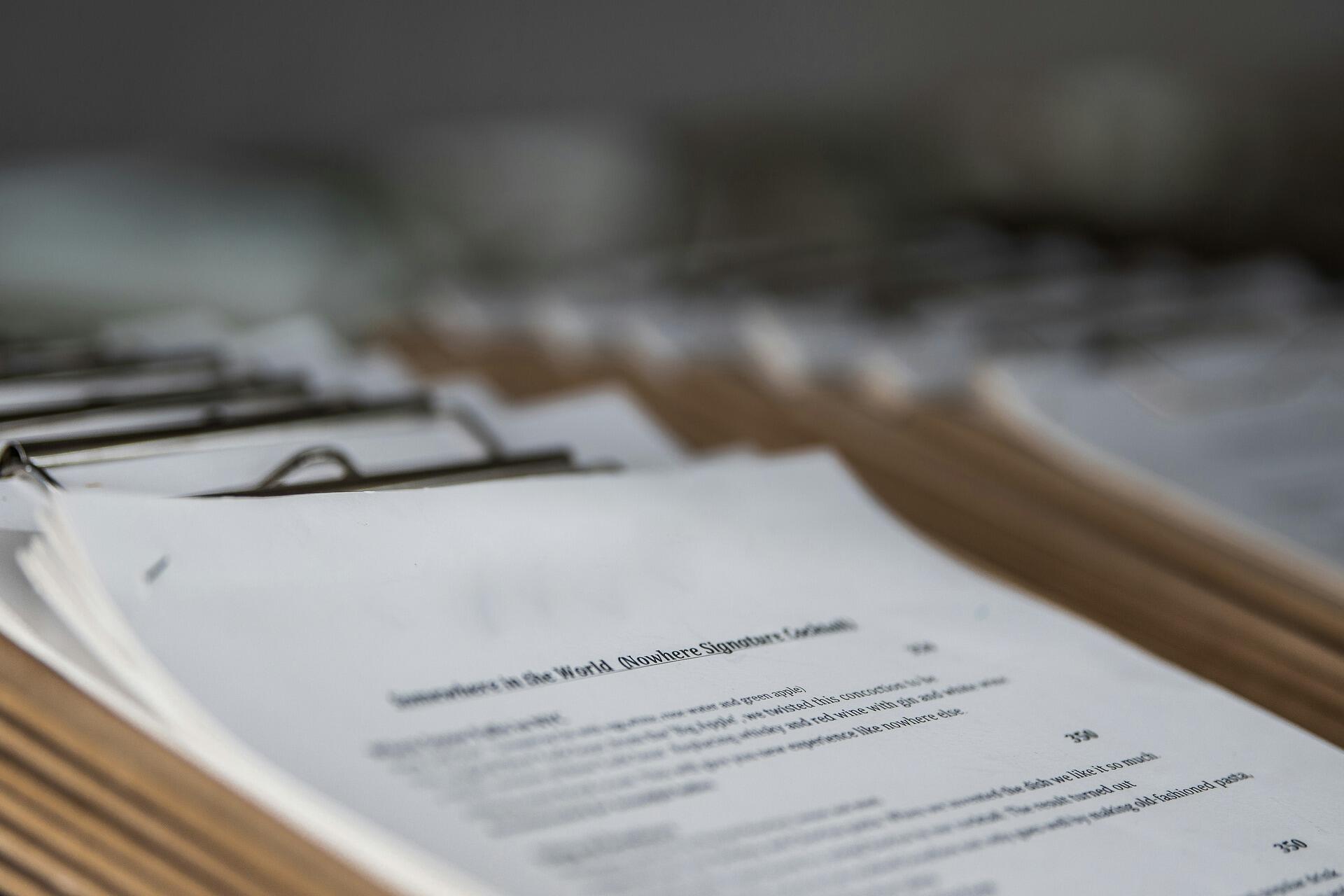 A stack of documents on clipboards symbolizing structured ACCA exam preparation and professional growth for Malaysian learners.