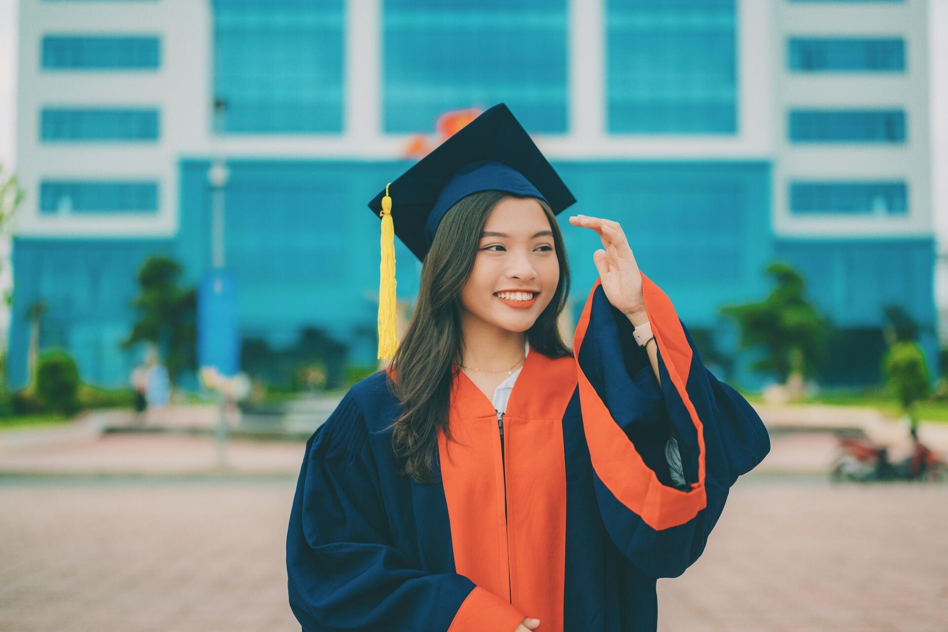 Graduate celebrating in a cap and gown, representing scholarship-supported pathways to ACCA qualification in Malaysia.
