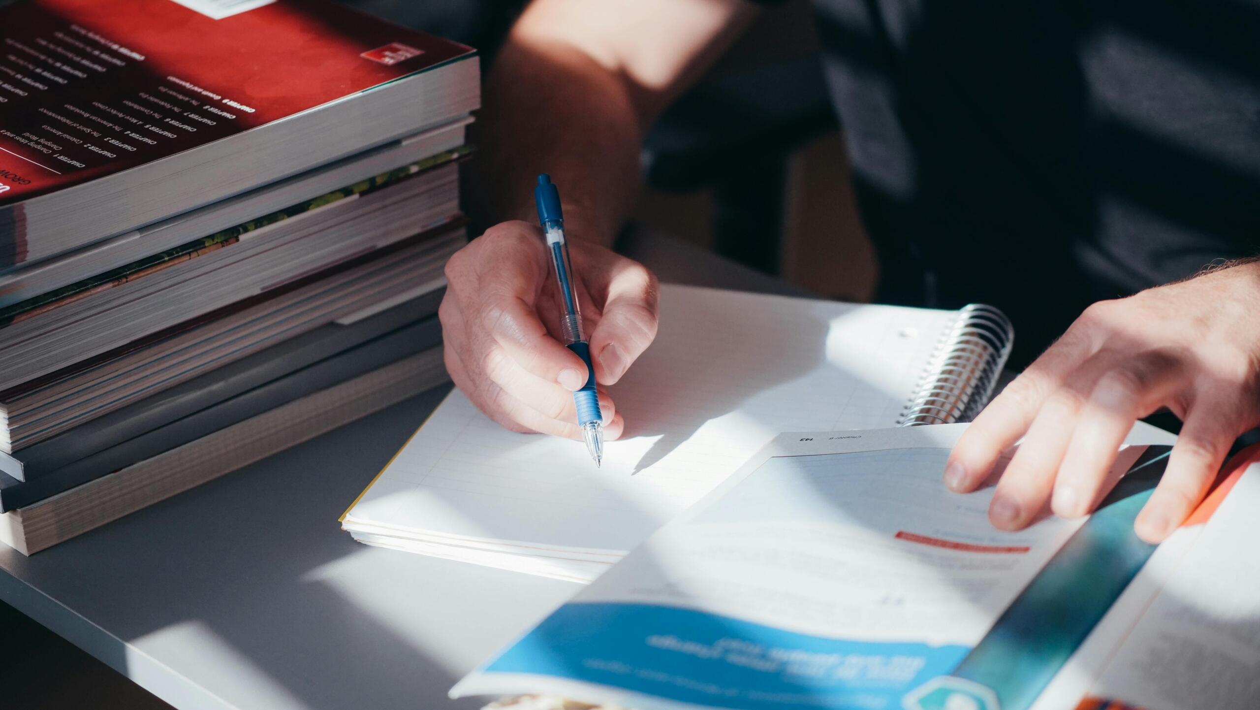 A person writing in a notebook