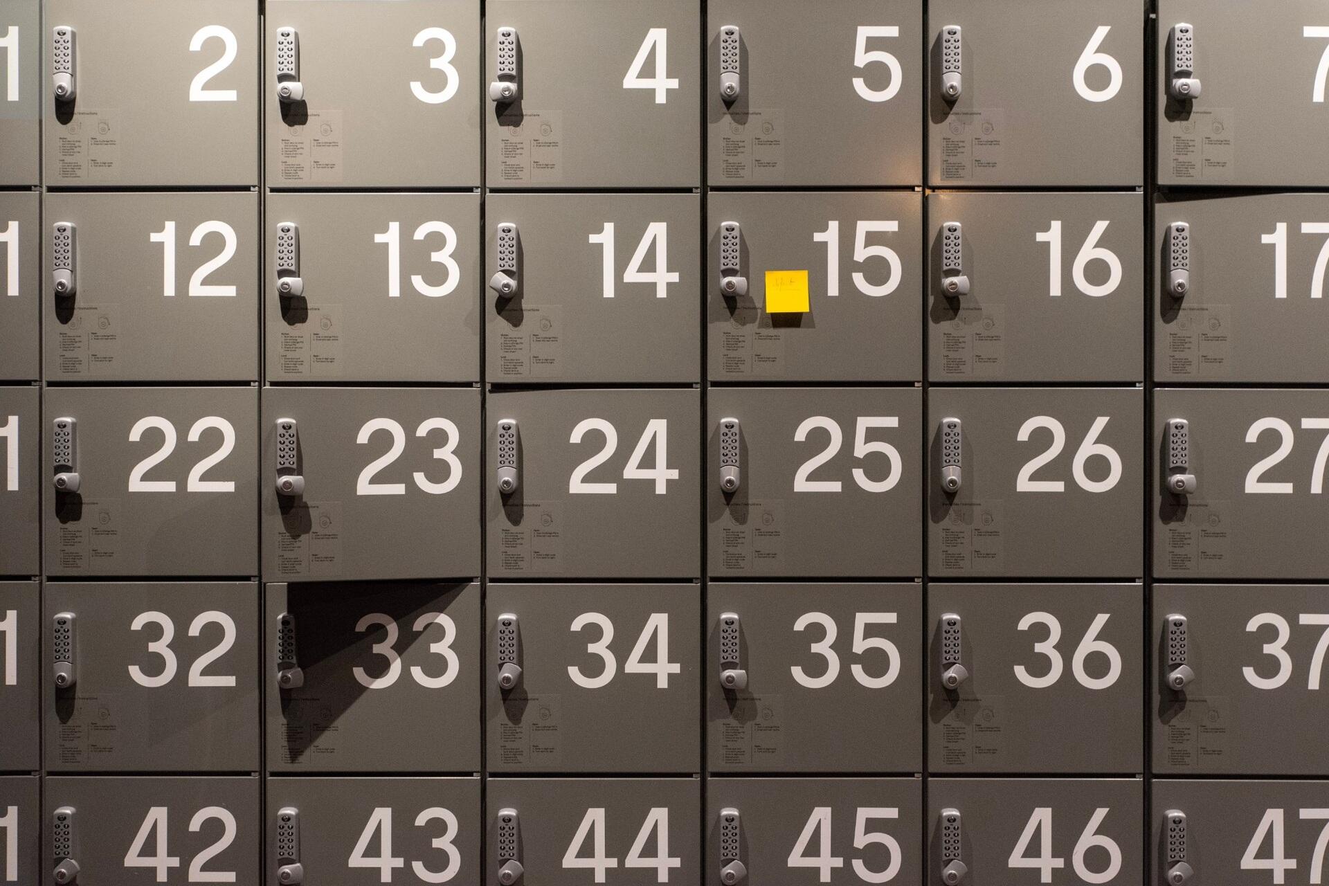 Rows of numbered lockers arranged in sequence, illustrating numbers, patterns and mathematical order.