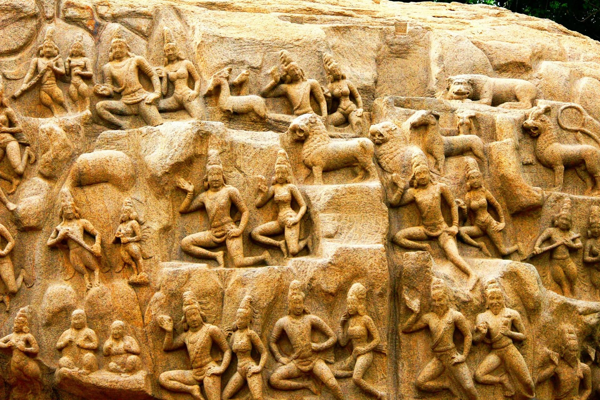 Ancient stone relief carving depicting figures, animals, and mythological scenes from South Indian temple art associated with Tamil cultural heritage.