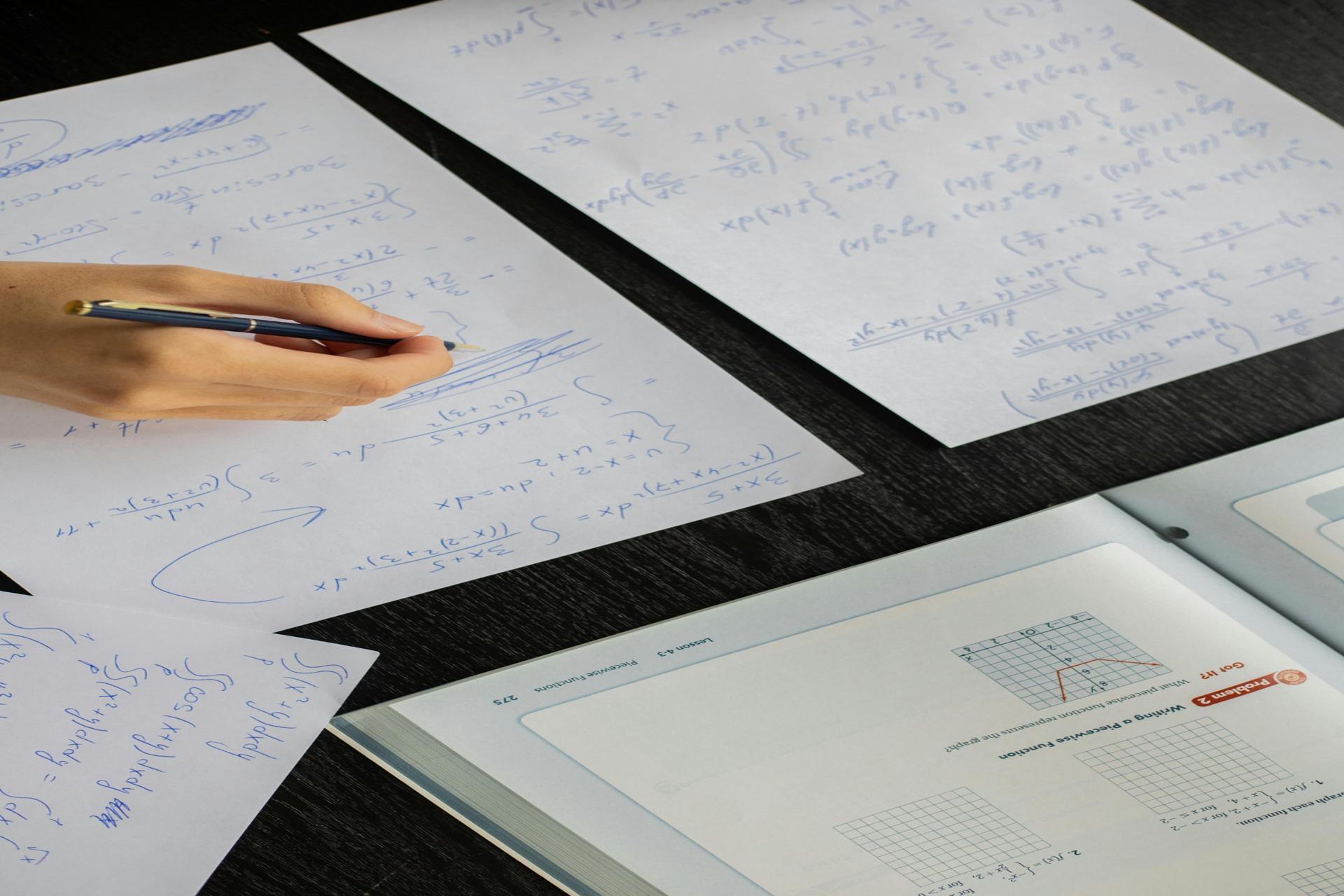 Student solving SPM mathematics problems with handwritten notes and formulas on paper