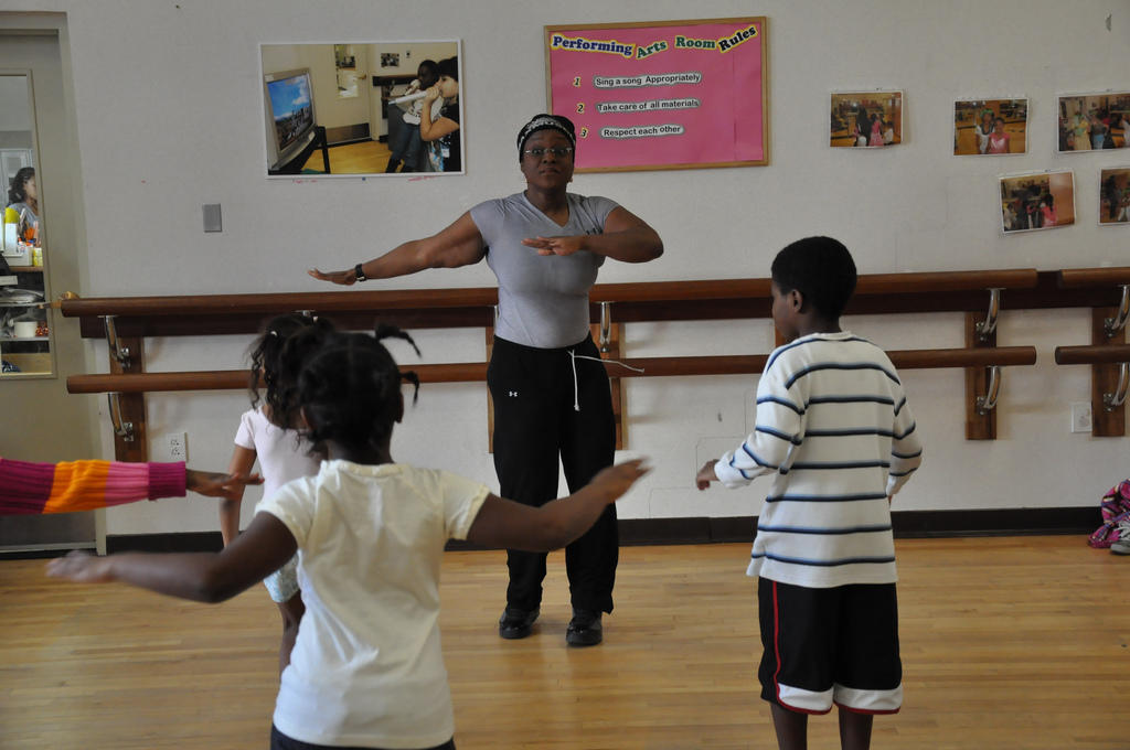 A PE teacher teaches children.
