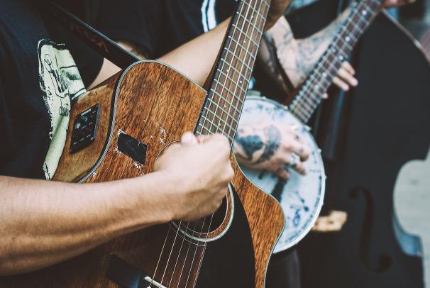An acoustic guitar and a banjo player