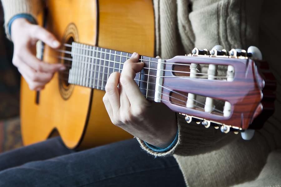 Someone learning the classical guitar.