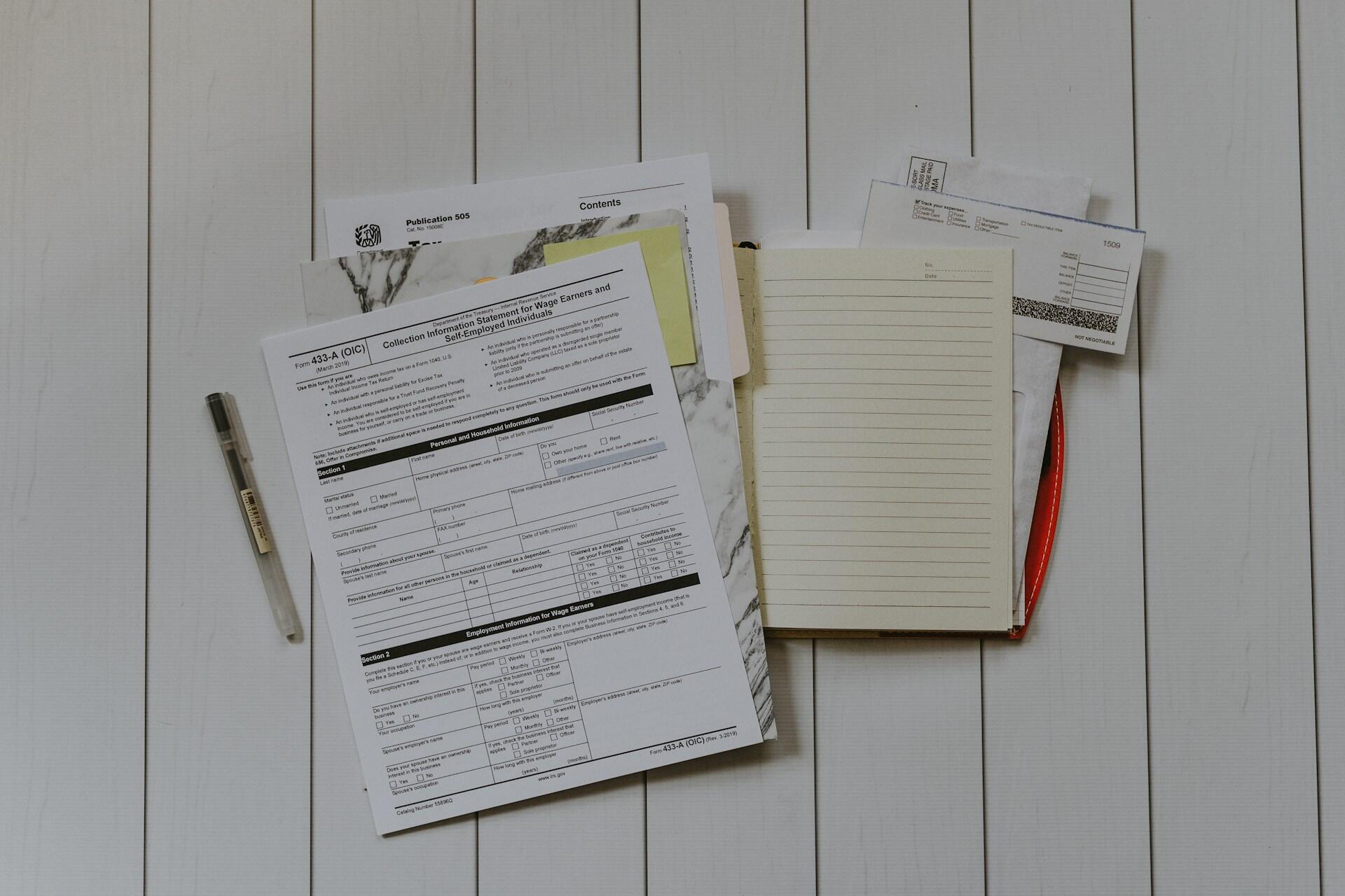 A study desk covered with worksheets and pens.