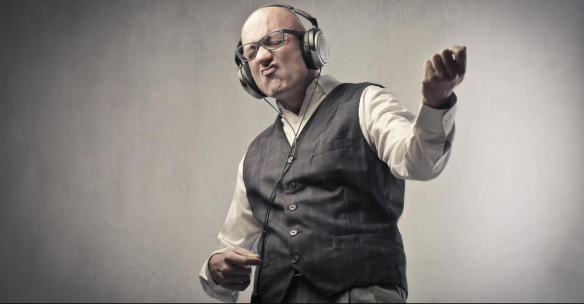 A man playing air guitar. It's important to listen to your music properly!