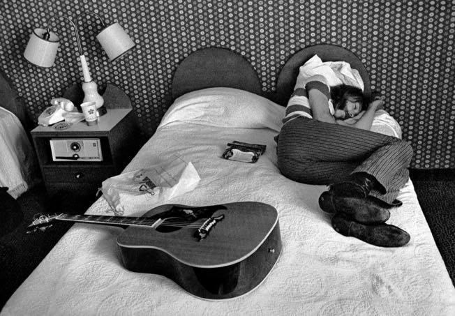 A guitarist not practicing in bed
