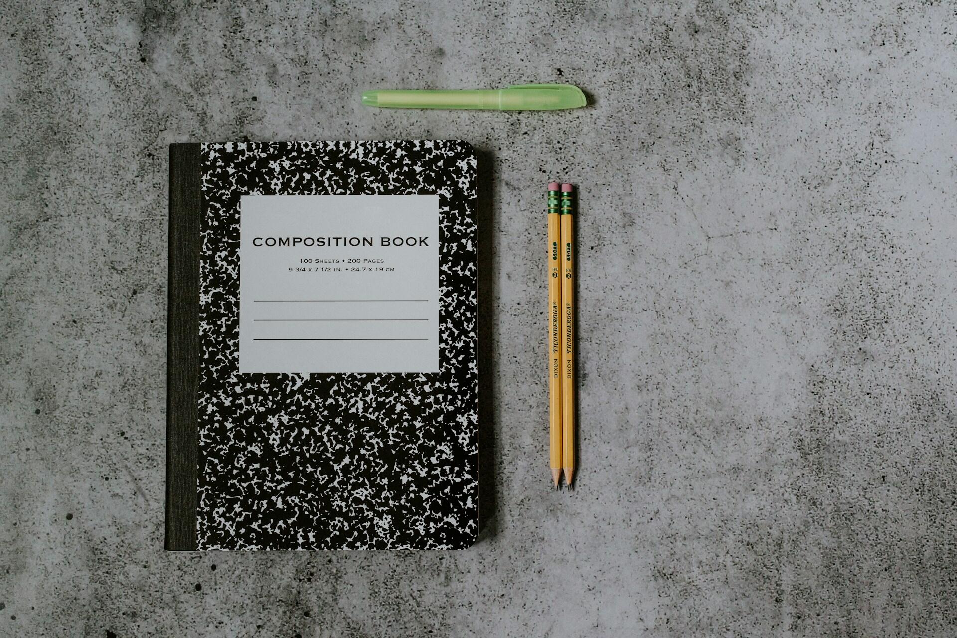 An open notebook with pencils and a highlighter ready for revision.