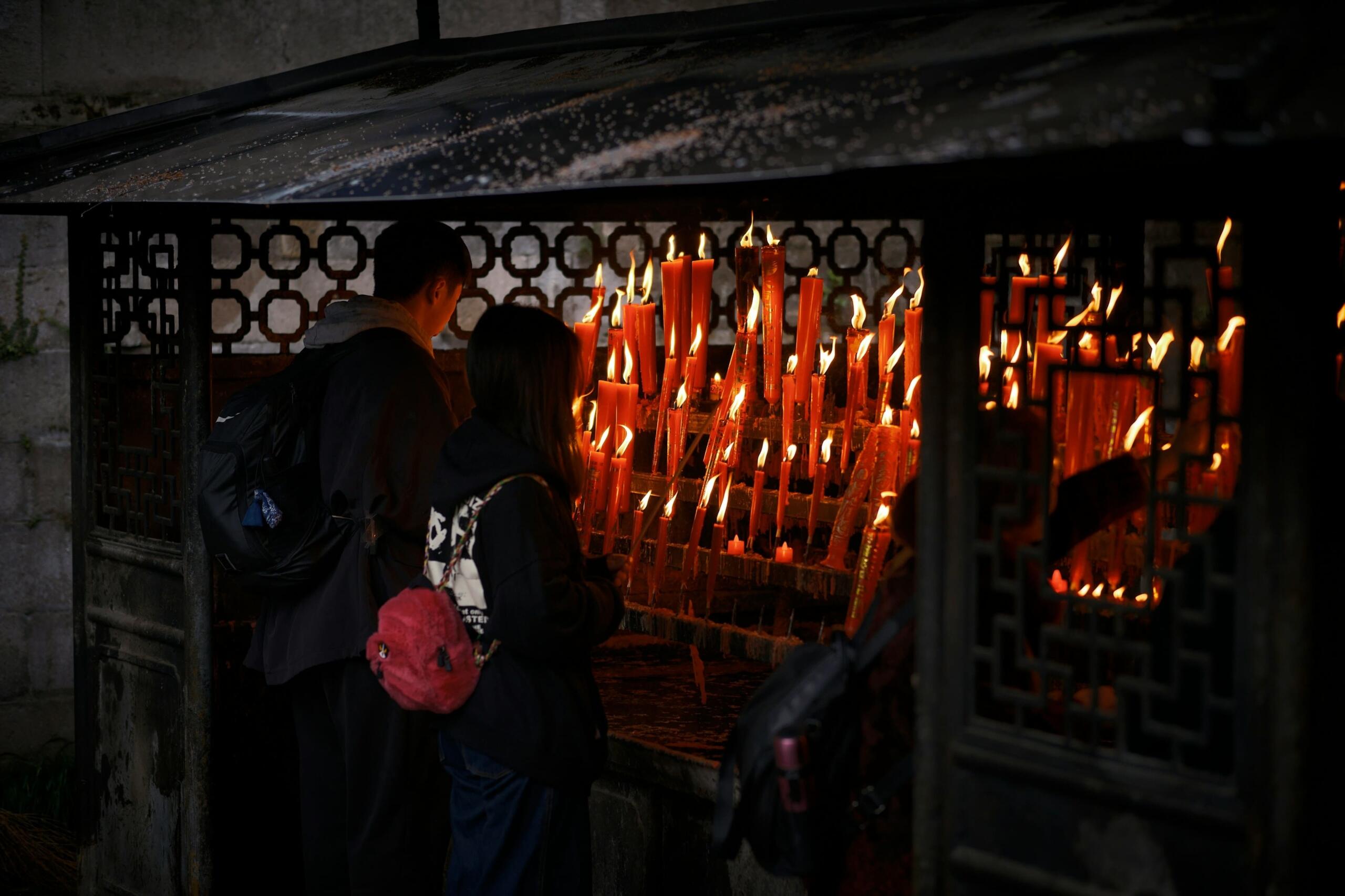 A couple praying at a temple in China.