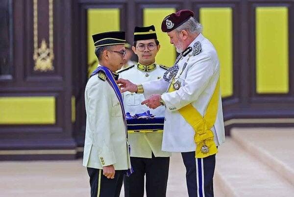 Communications Minister Fahmi Fadzil receives a Datukship from the 17th Yang di-Pertuan Agong, Sultan Ibrahim.