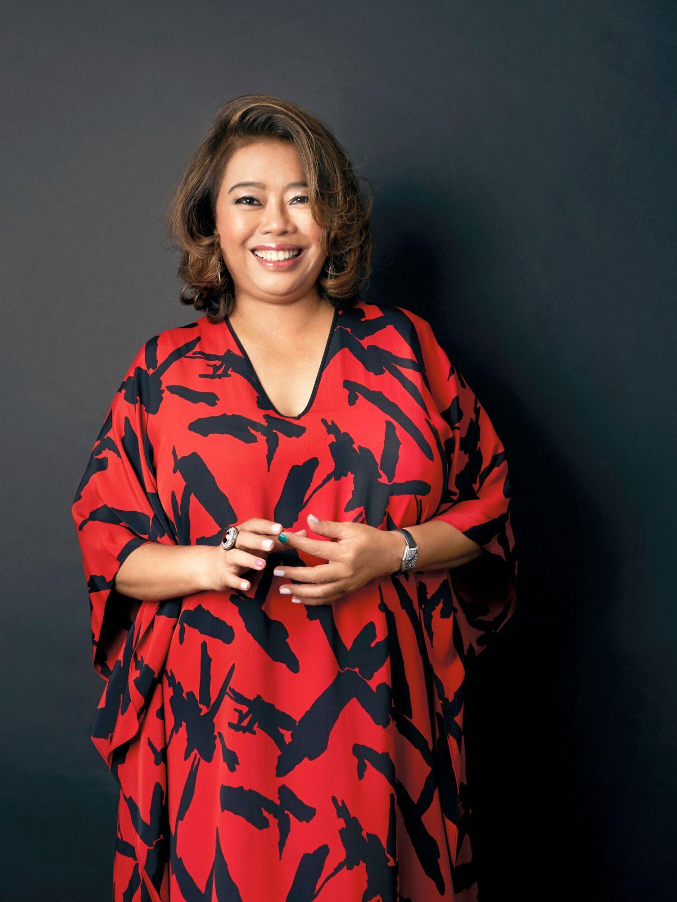 Dato' Dr Hartini Zainudin smiling at the camera, wearing a red and black dress.