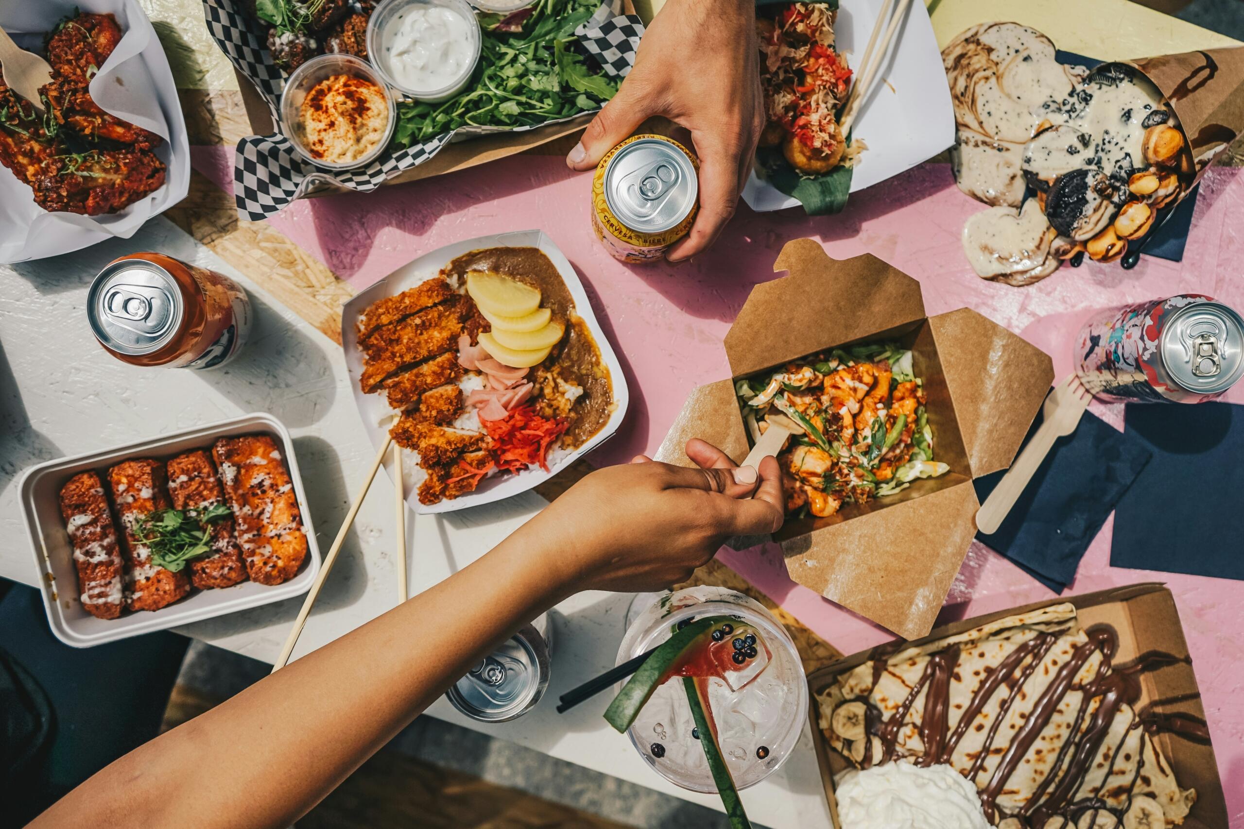 A table set with various dishes and drinks, showcasing a colourful spread of food for a gathering.