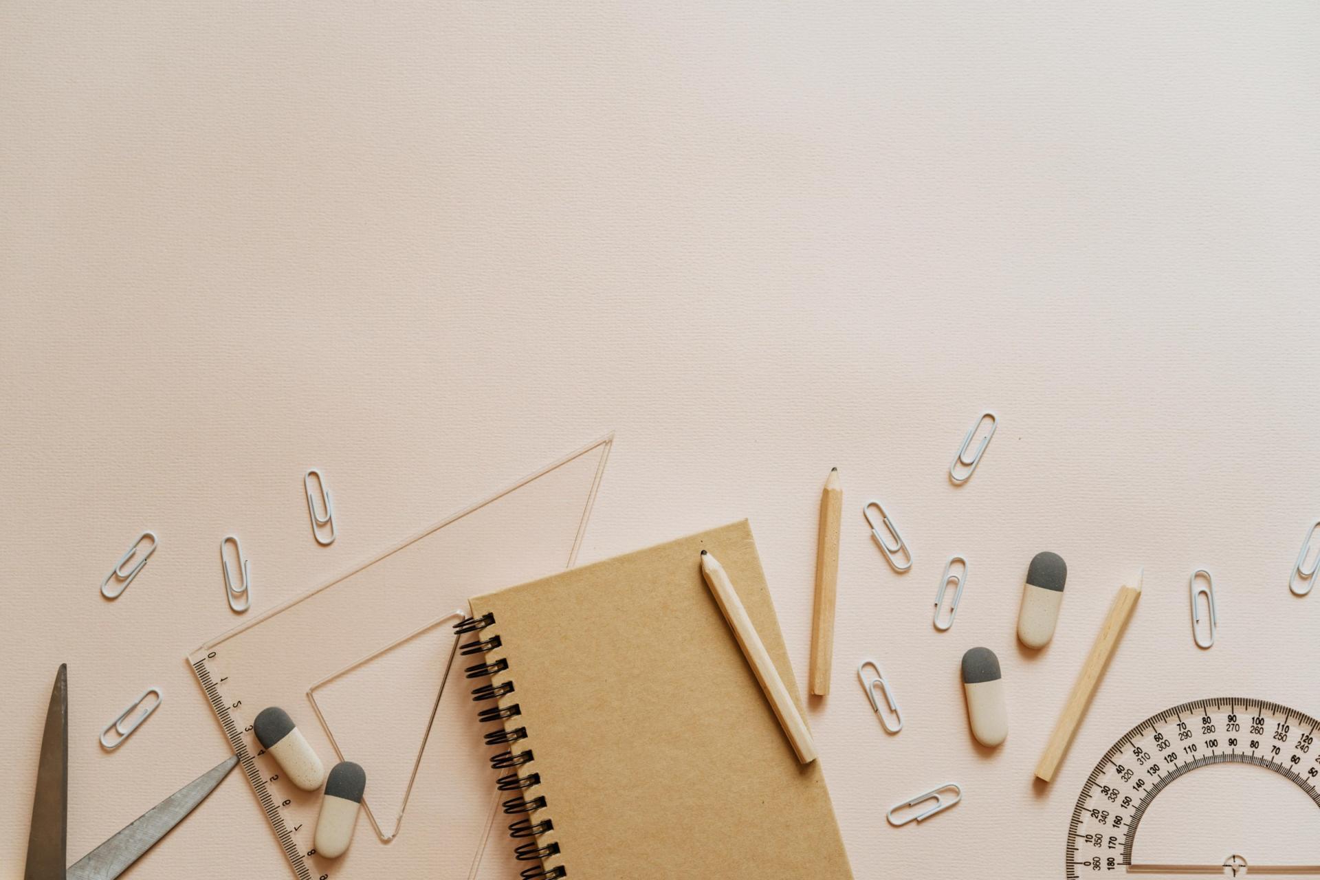 flat lay of notebook, ruler, protractor, pencils and stationery for SPM Mathematics study