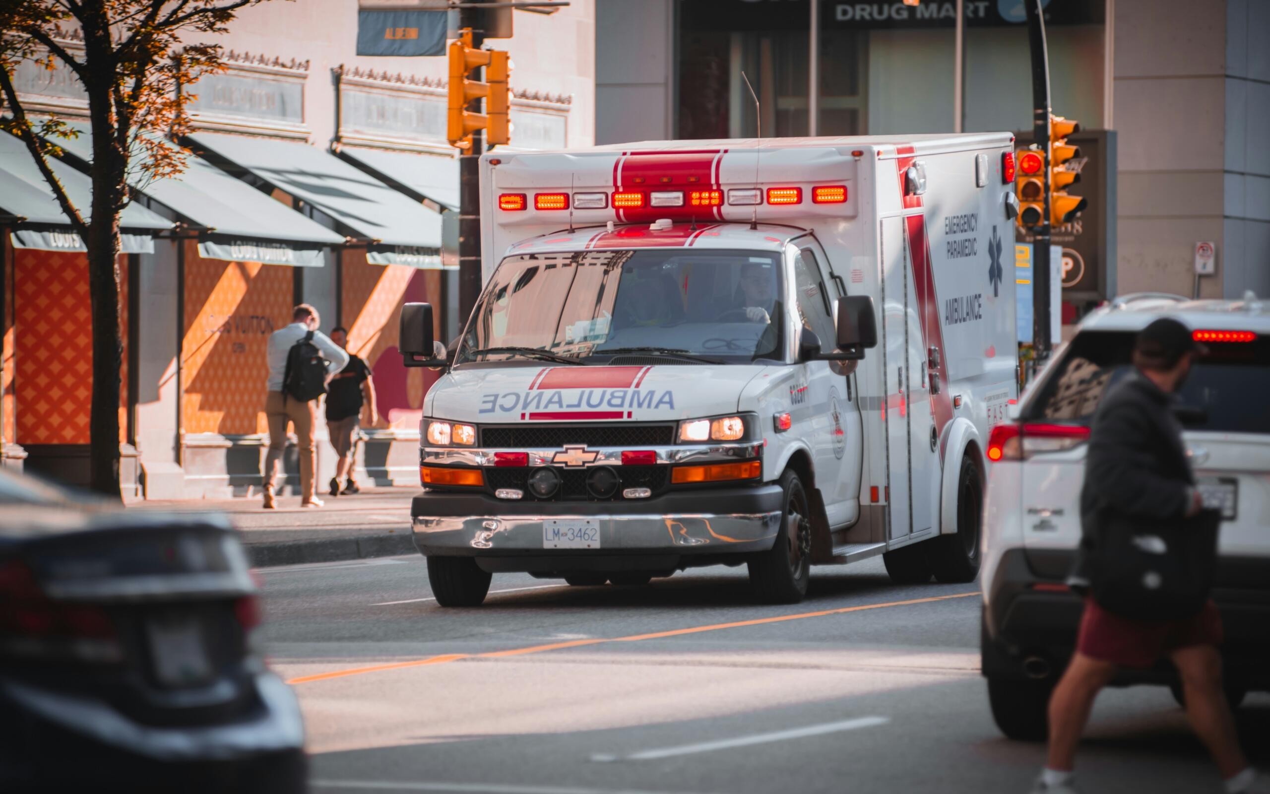 An ambulance along a busy city street.