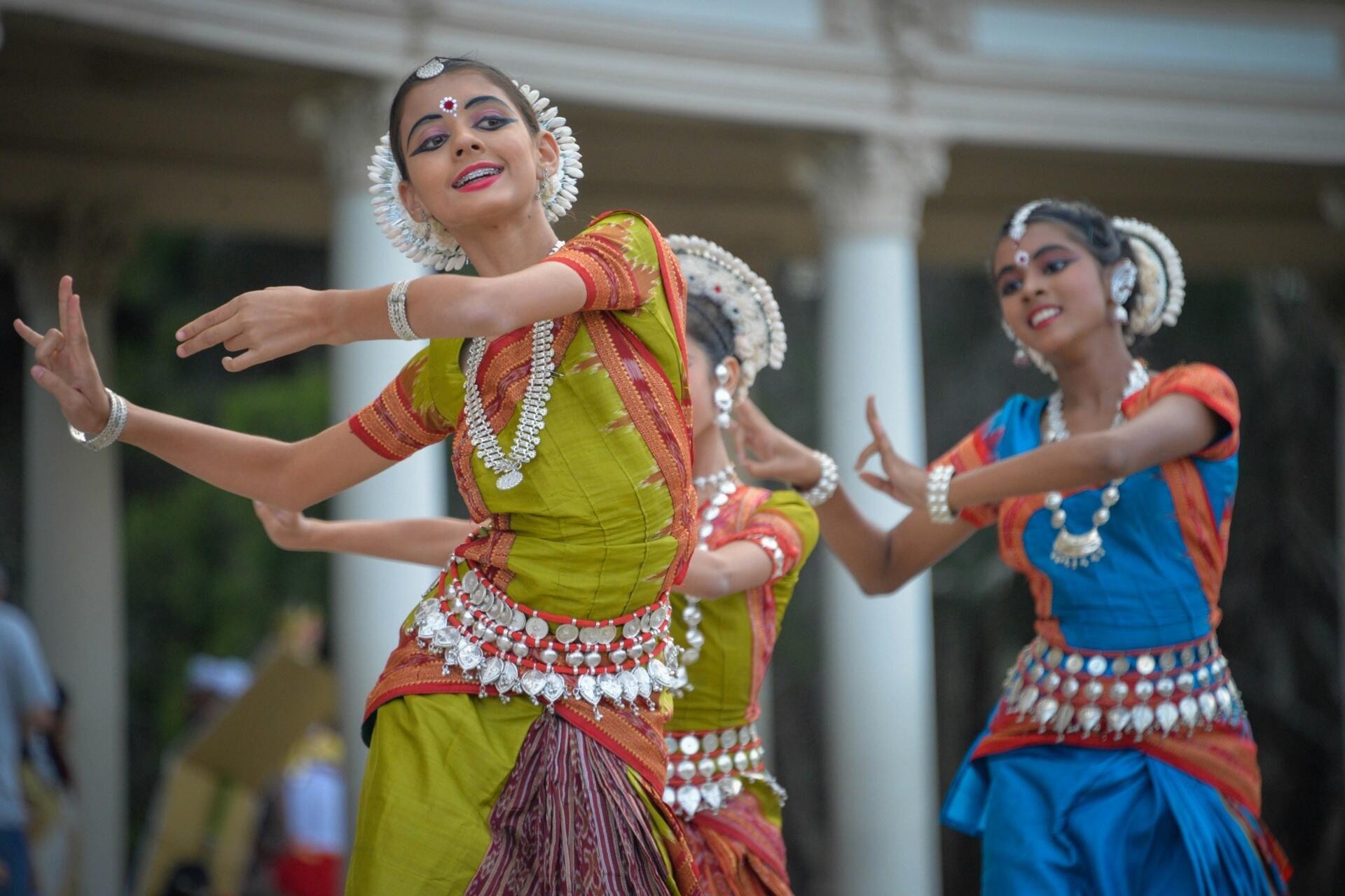 Young dancers performing a traditional South Indian classical dance in colourful cultural attire and jewellery.