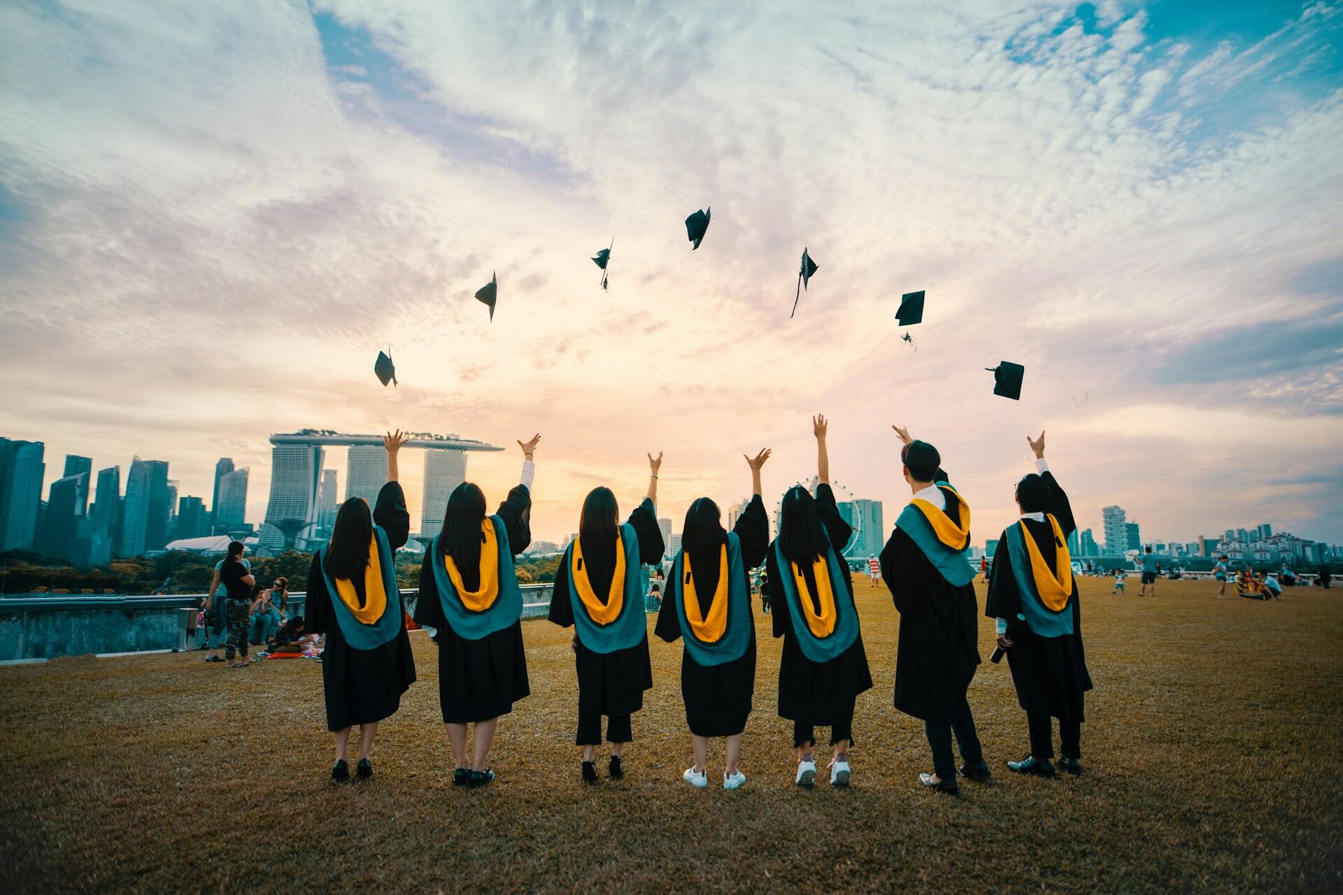 Graduates in gowns throwing their caps in celebration
