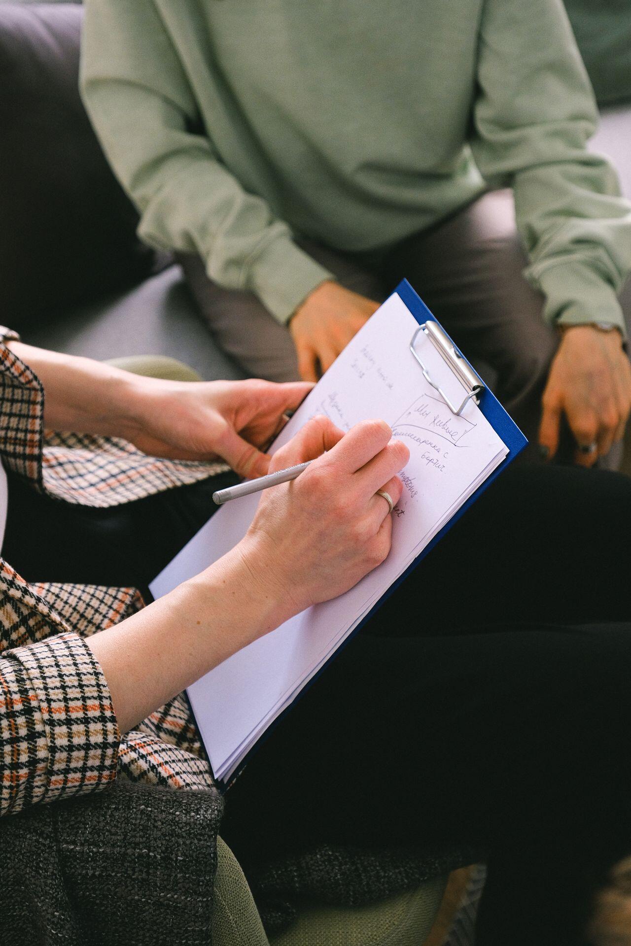a picture of a person writing on a checklist