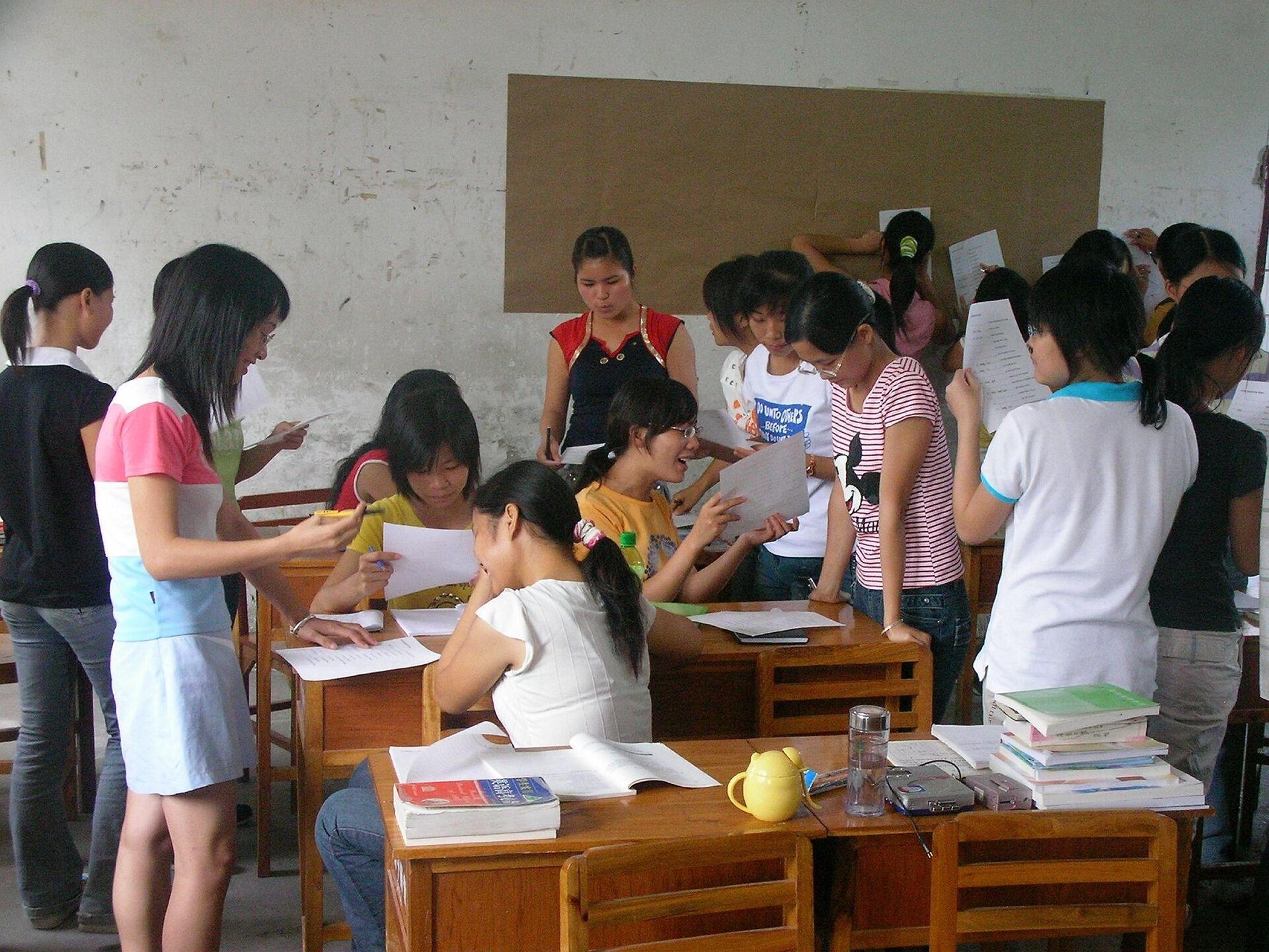 A diverse group of individuals engaged in a classroom setting, participating in a discussion or activity.