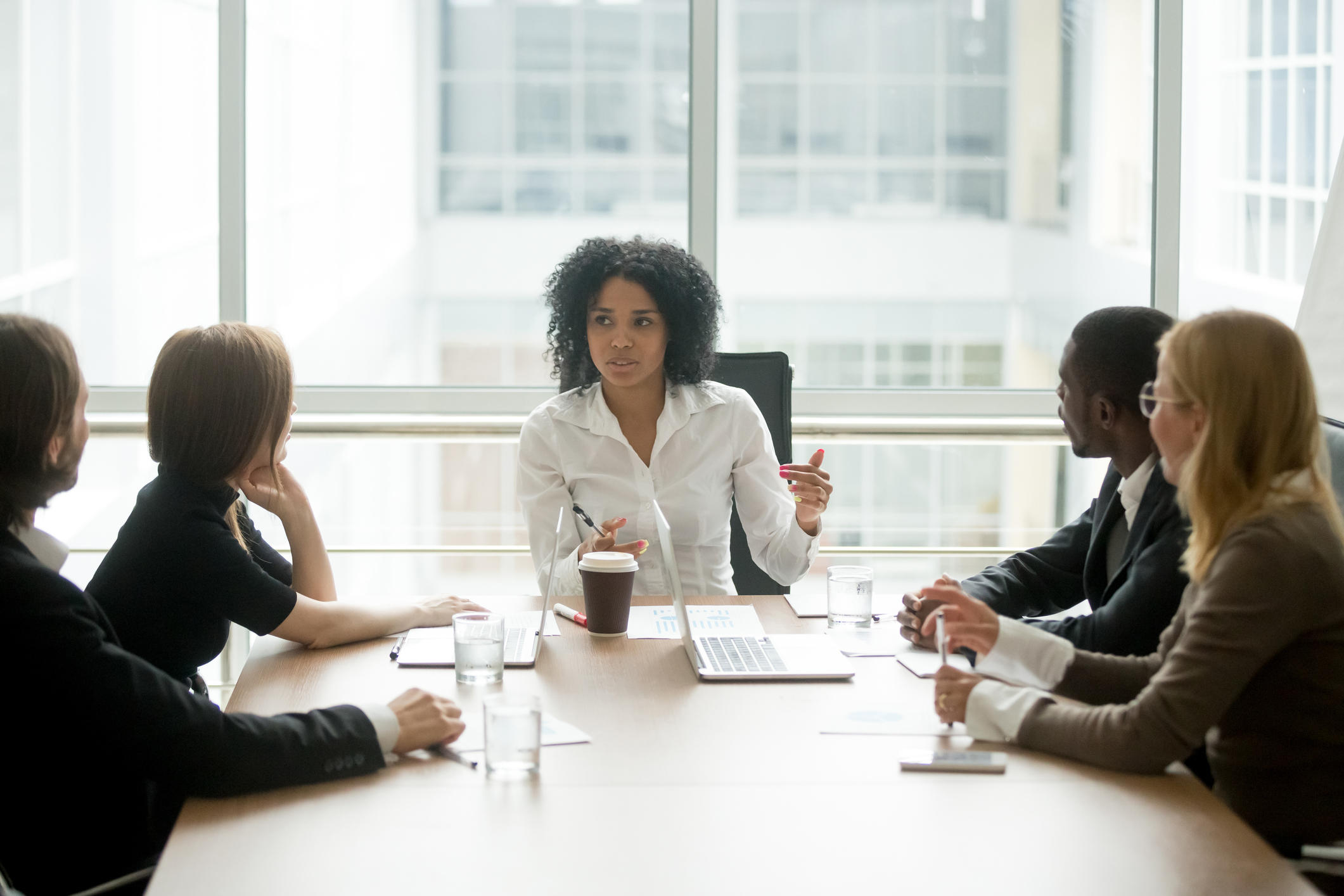Female boss talking to employees