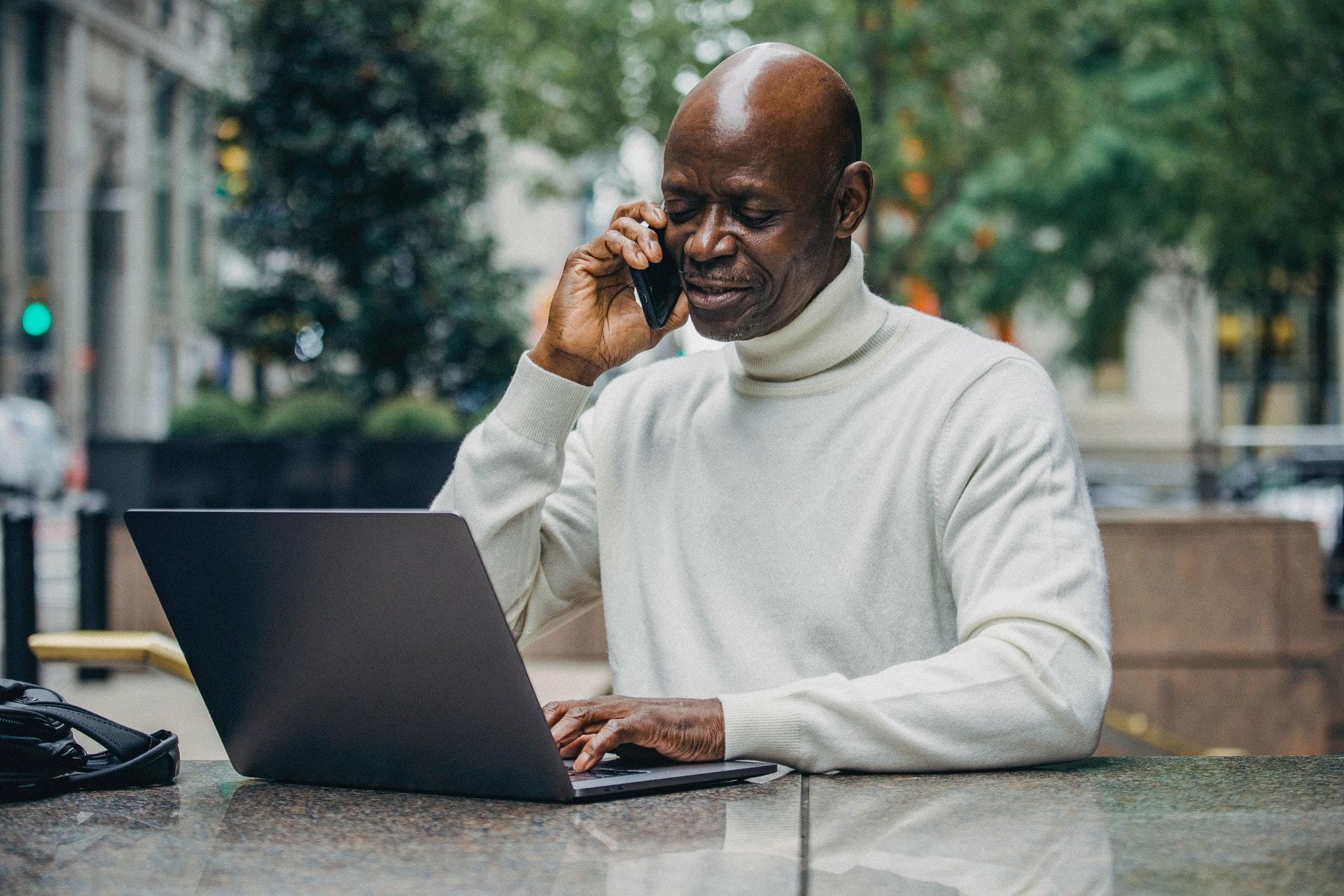 An old man operating a computer